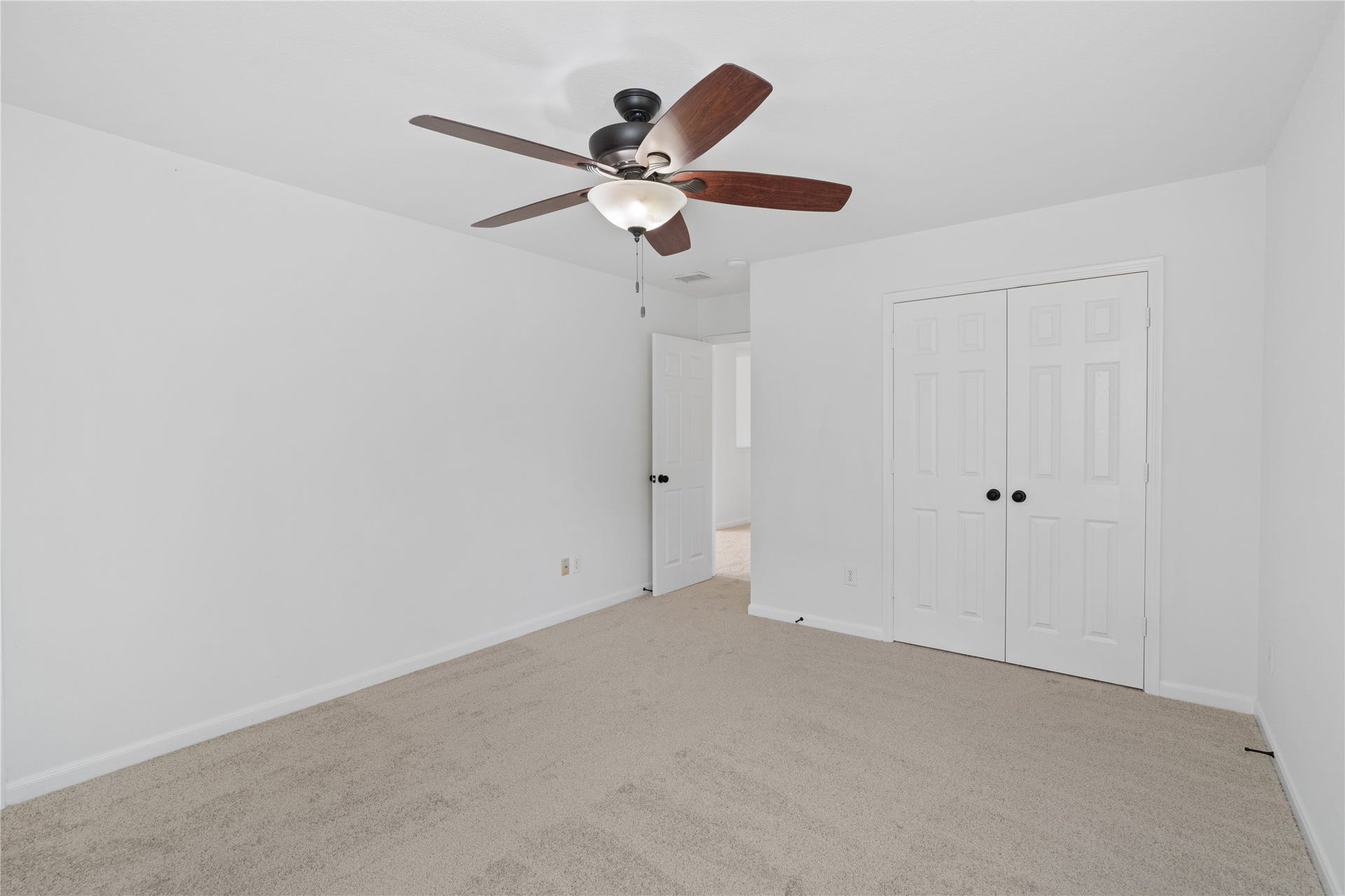 21611 Manitou Falls Lane, Katy, TX 77449 Bedroom Reverse view highlights the double-door closet, ceiling fan, and versatile wall space for a variety of furniture arrangements.