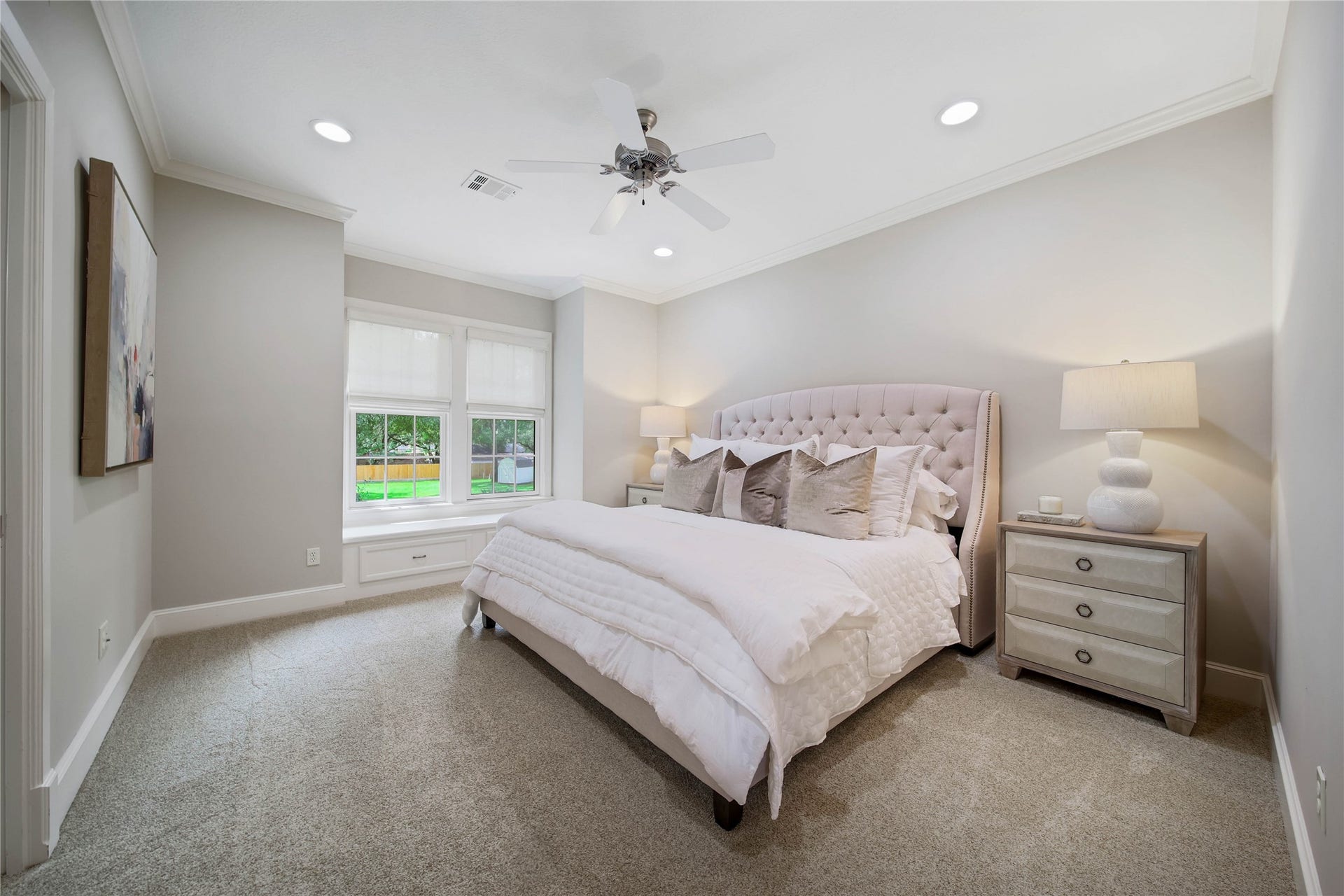 12635 Hunters Canyon Lane, Cypress, TX 77429 A serene bedroom featuring plush carpeting, ample natural light from large windows, complemented by soft, neutral tones. This can serve as the guest, ensuite bedroom and has a walk-in closet.