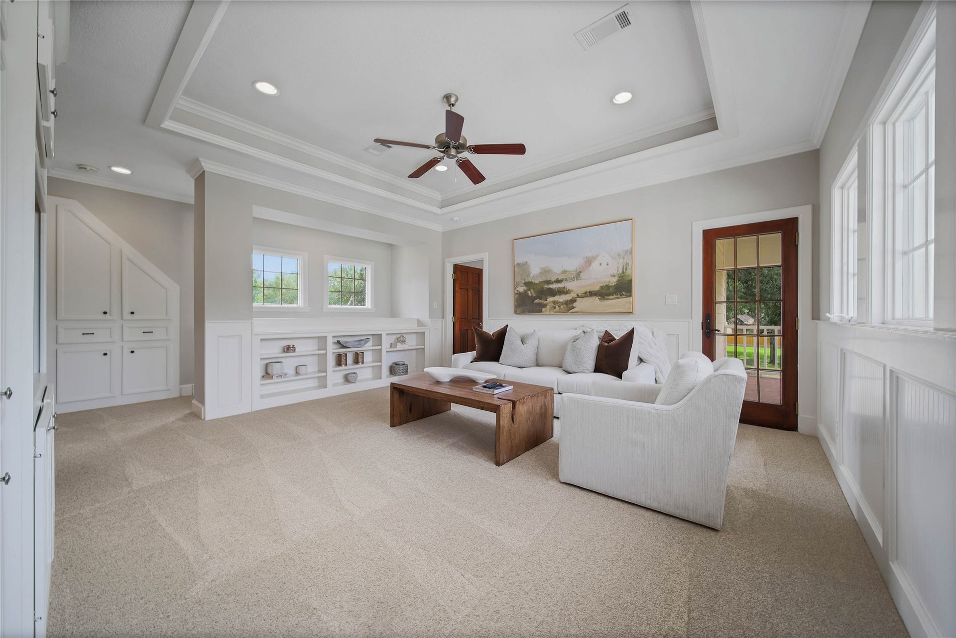 12635 Hunters Canyon Lane, Cypress, TX 77429 Bright and inviting flex space with plush carpeting, and abundant natural light from large windows, complemented by built-in shelving and laundry shoot at the top of the stairs. The French door leads to the balcony.
