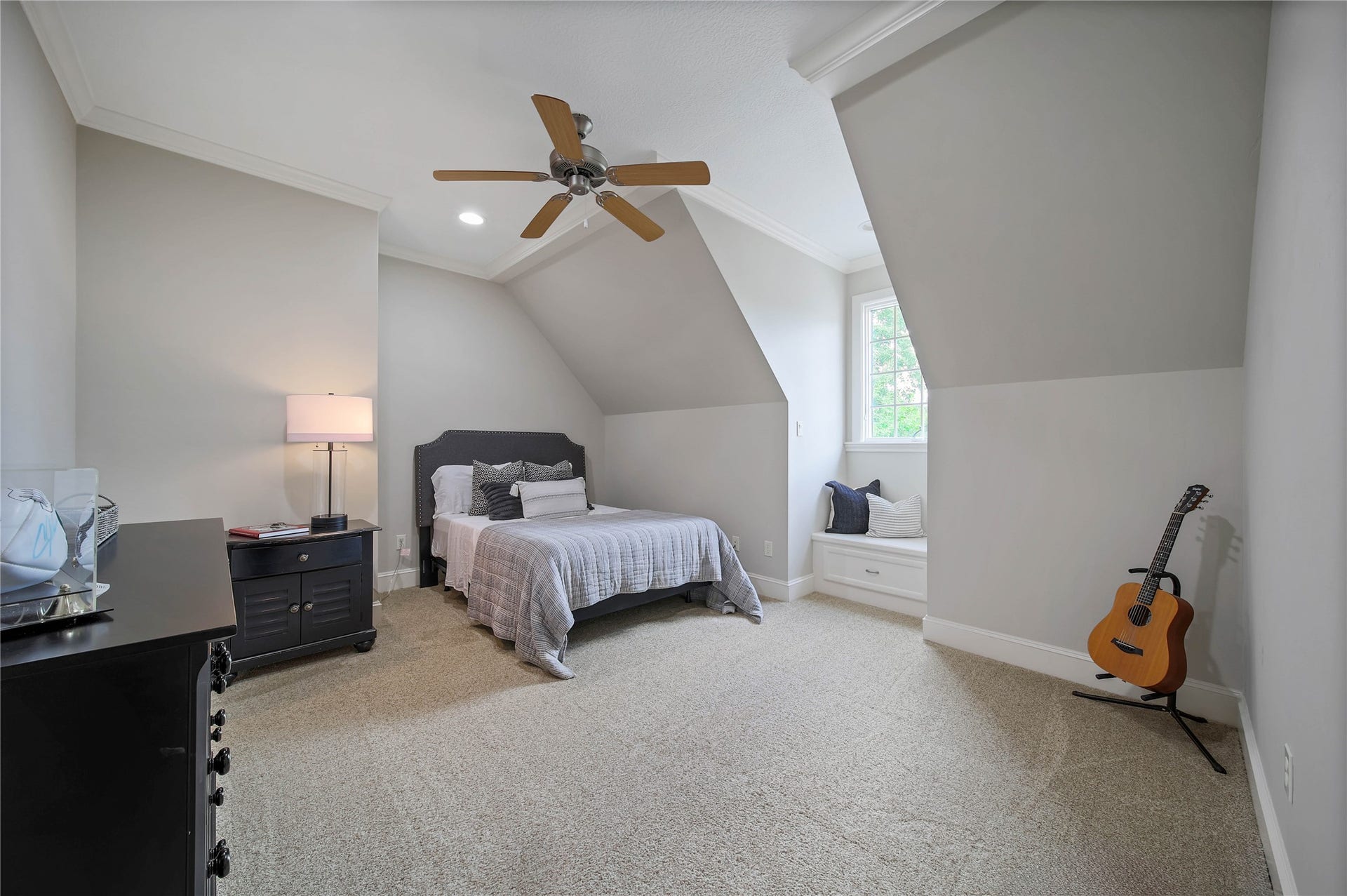 12635 Hunters Canyon Lane, Cypress, TX 77429 Another secondary bedroom with angled ceilings, a ceiling fan, and a charming window nook. This bedroom shares a Jack-n-Jill bathroom with the third bedroom.