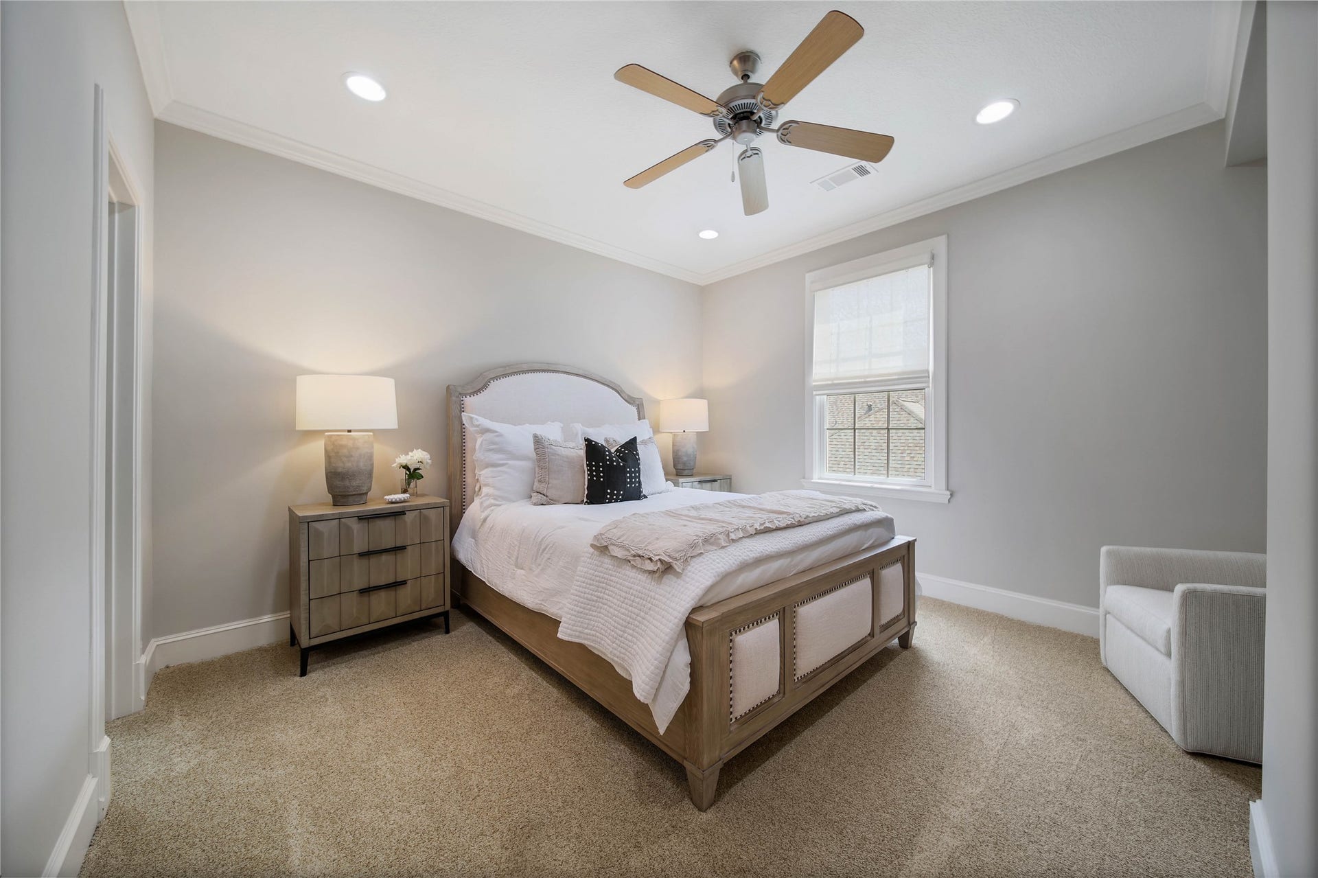 12635 Hunters Canyon Lane, Cypress, TX 77429 Charming bedroom with soft gray walls, cozy carpet, and a stylish ceiling fan. There is natural light from the window and recessed lighting to make this bedroom light and bright.