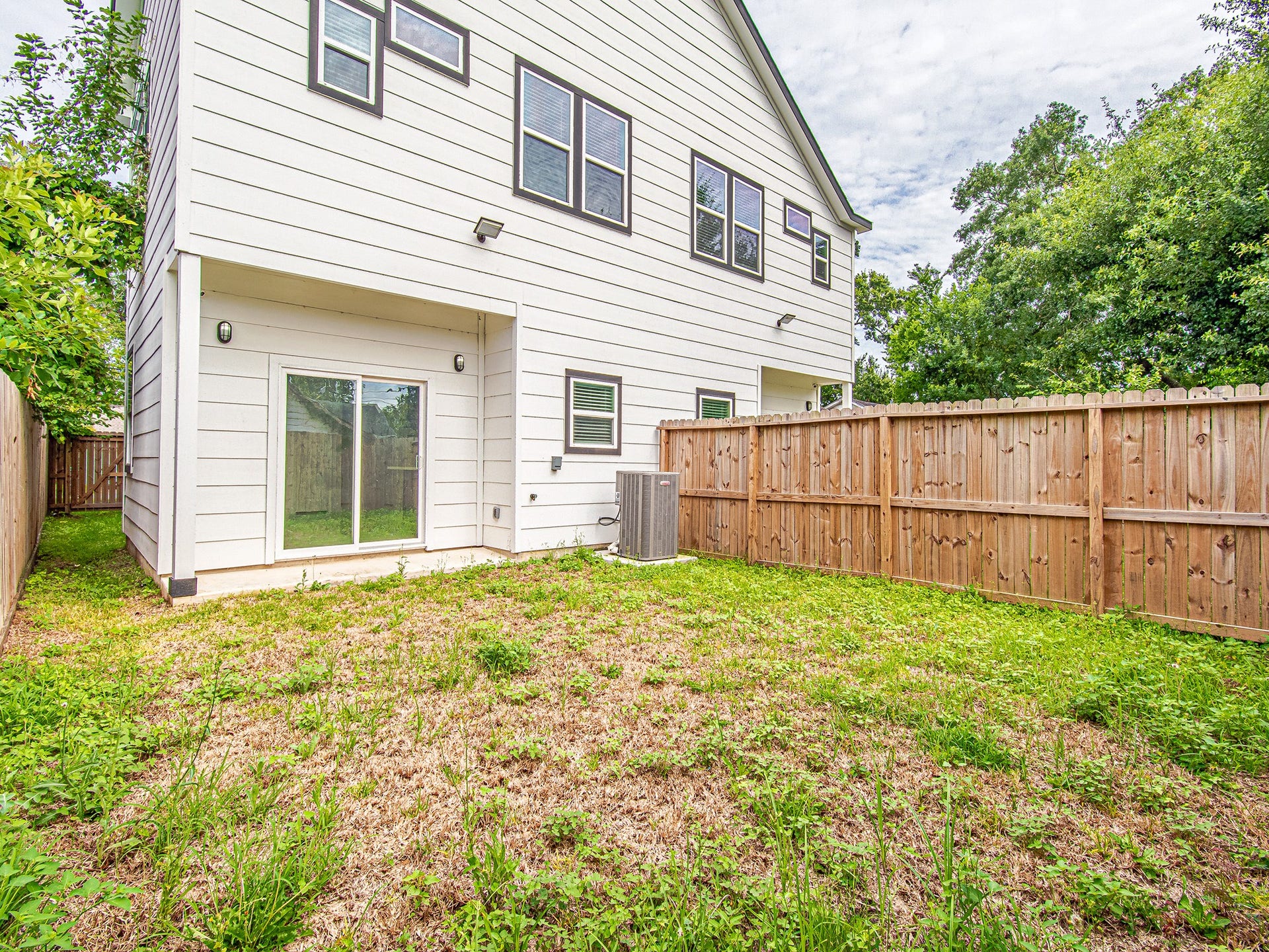 Fully fenced backyard providing space for outdoor relaxation, play, or entertaining.