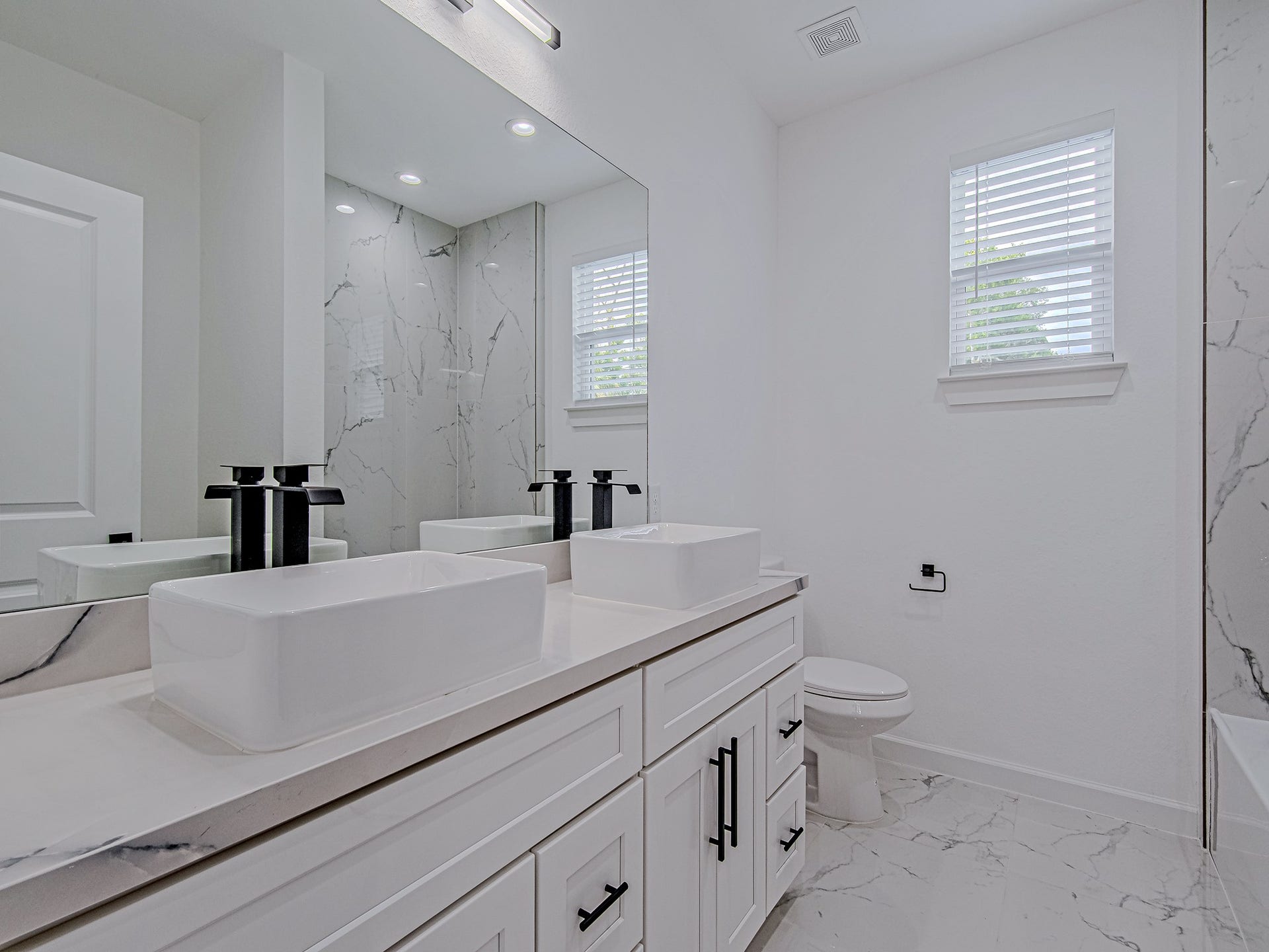 Additional bathroom featuring a modern vanity, stylish fixtures, and plenty of counter space.