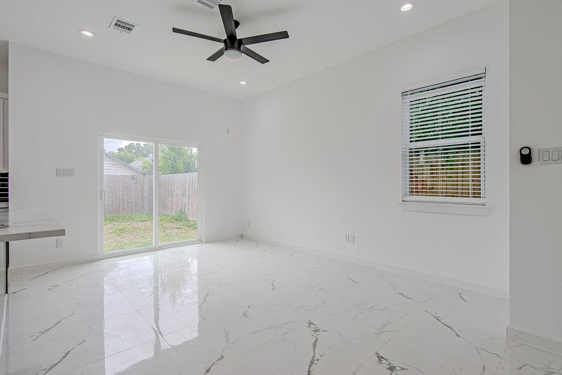 Inviting living area with large windows and an airy layout ideal for relaxing or entertaining guests.
