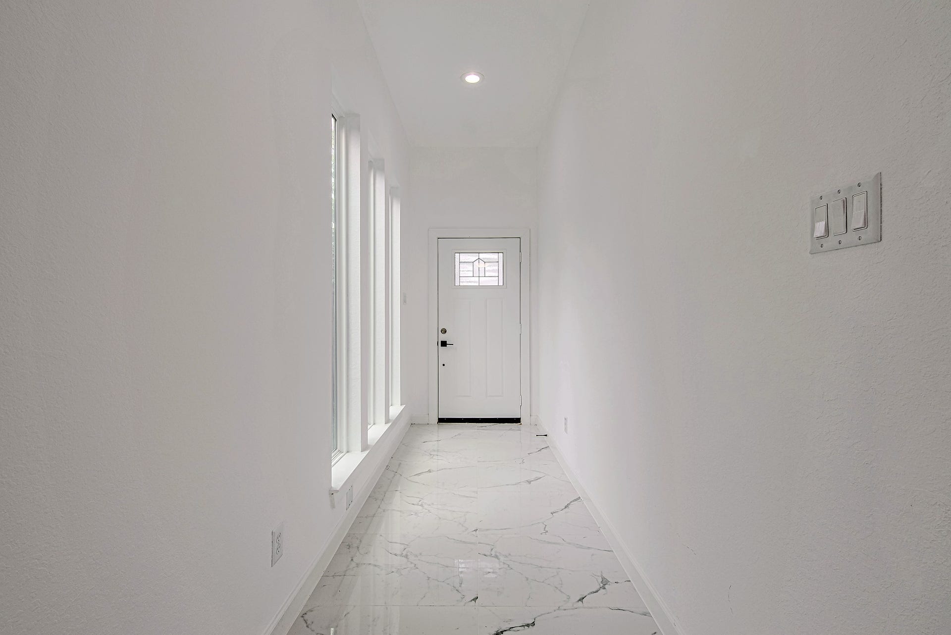 Bright hallway providing access to the home's bedrooms and living spaces.