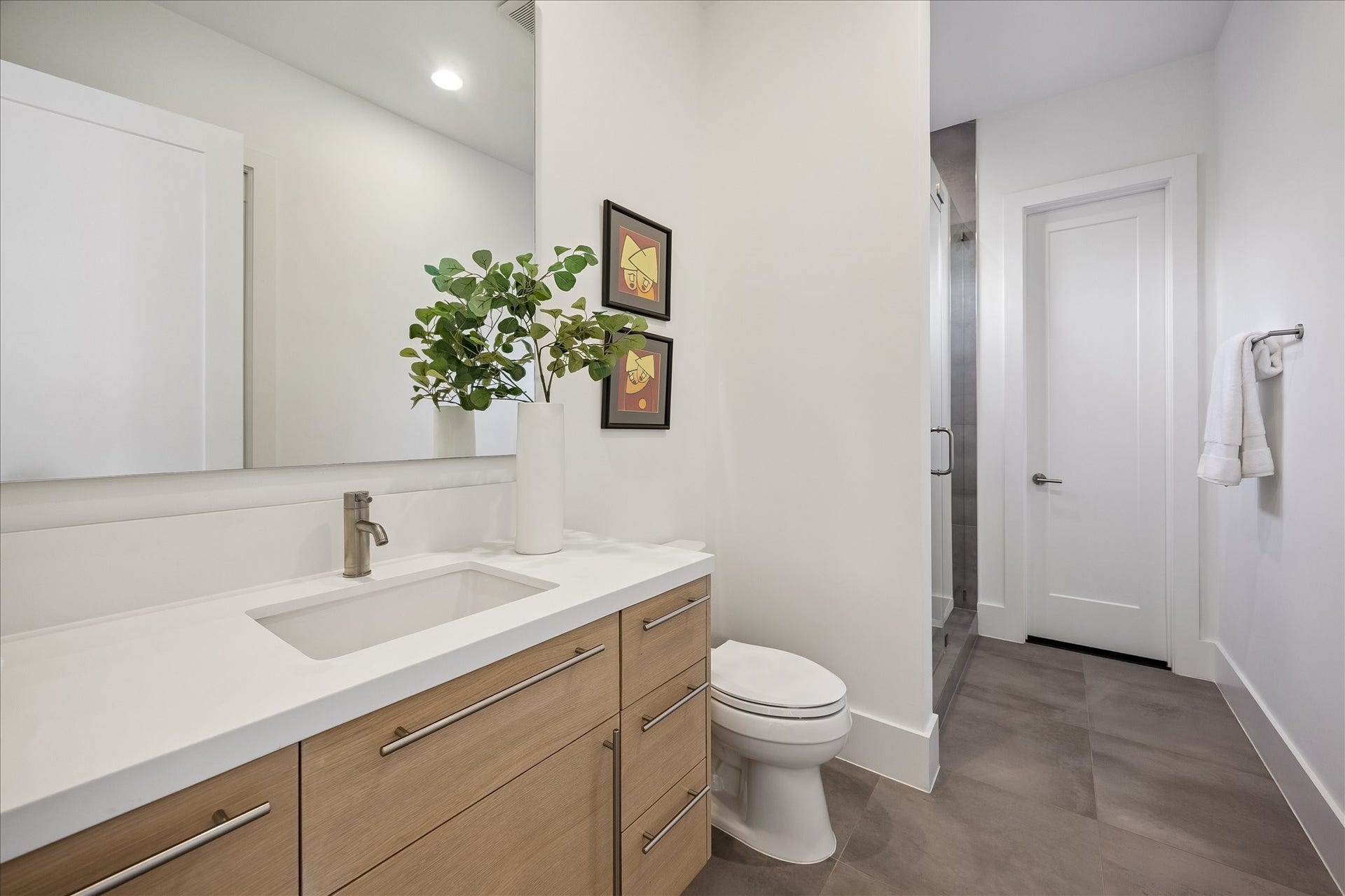 Elegant third ensuite bath with a spacious walk-in closet and a stylish, functional vanity for all your personal care needs.