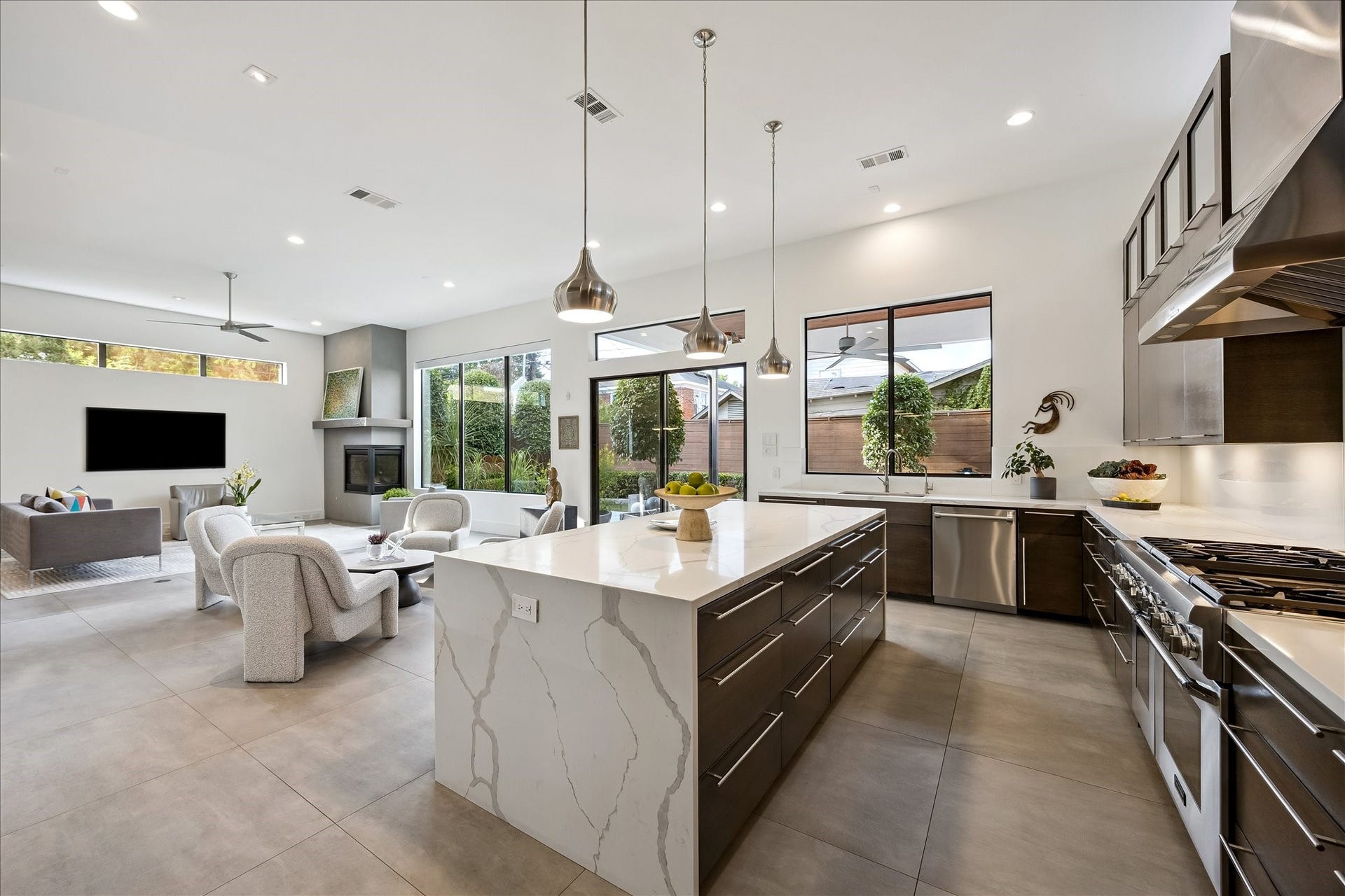 Enjoy efficient hot water from a tankless system and experience easy access with custom cabinetry featuring soft-close drawers and hidden runners for maximum storage.