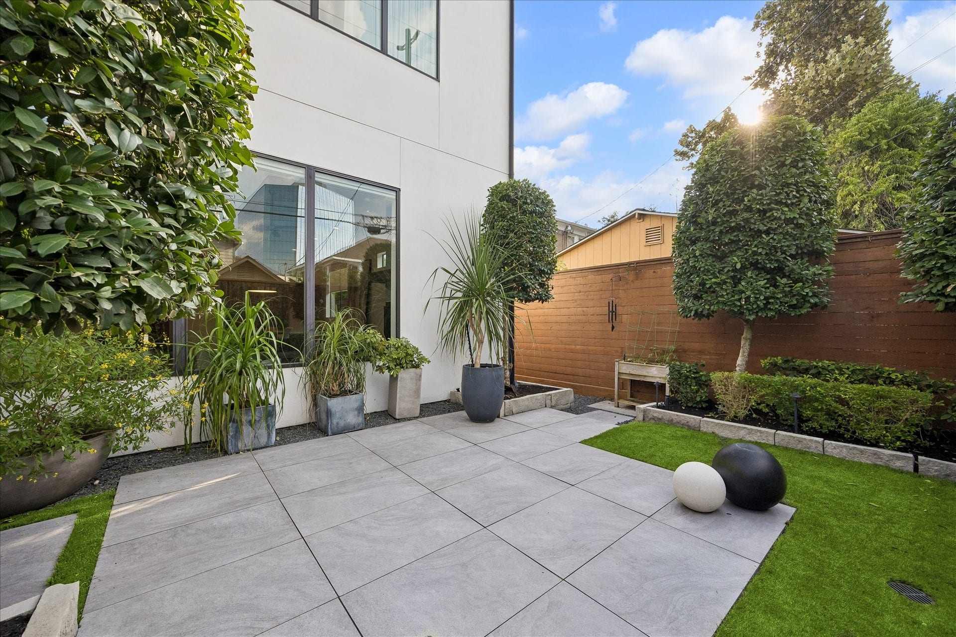 Experience a stunningly landscaped backyard designed for relaxation and ease, featuring a mosquito control system for uninterrupted enjoyment and a sprinkler system for lush greenery year-round.