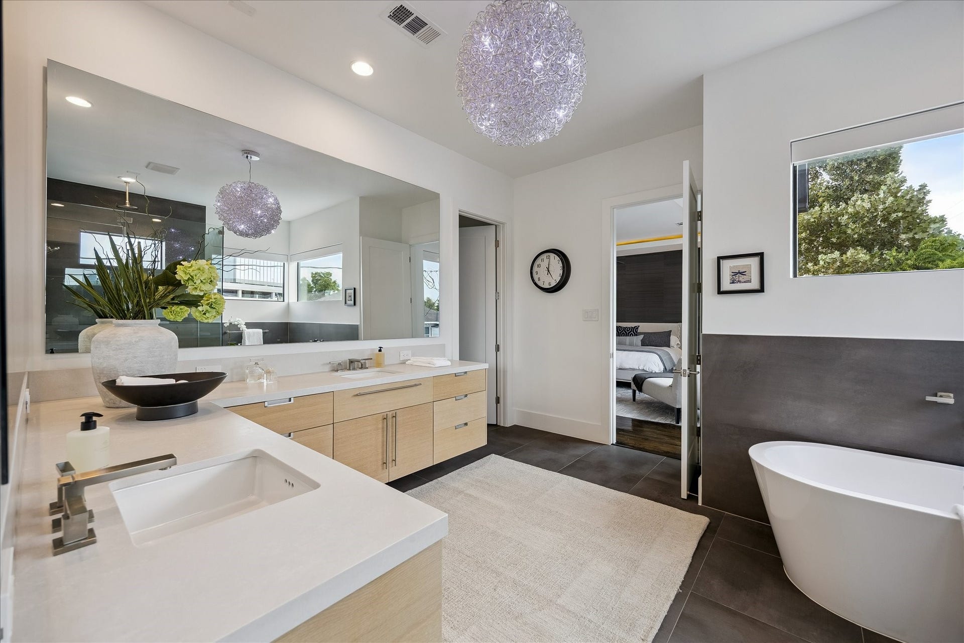 Indulge in modern luxury with quartz double vanities and a spacious custom walk-in closet, creating the perfect retreat for relaxation and organization.