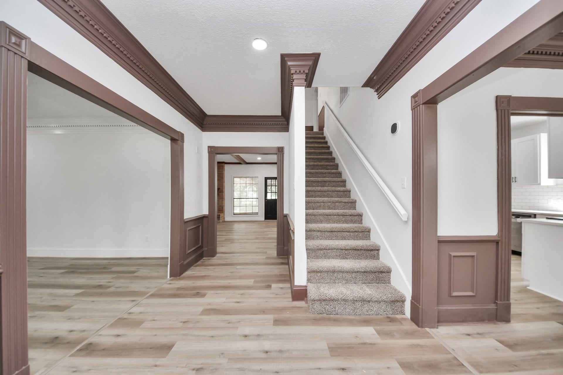 8503 Rebawood Drive, Humble, TX 77346 Charming entryway with elegant wood trim, modern flooring, and a welcoming staircase leading to the upper level.