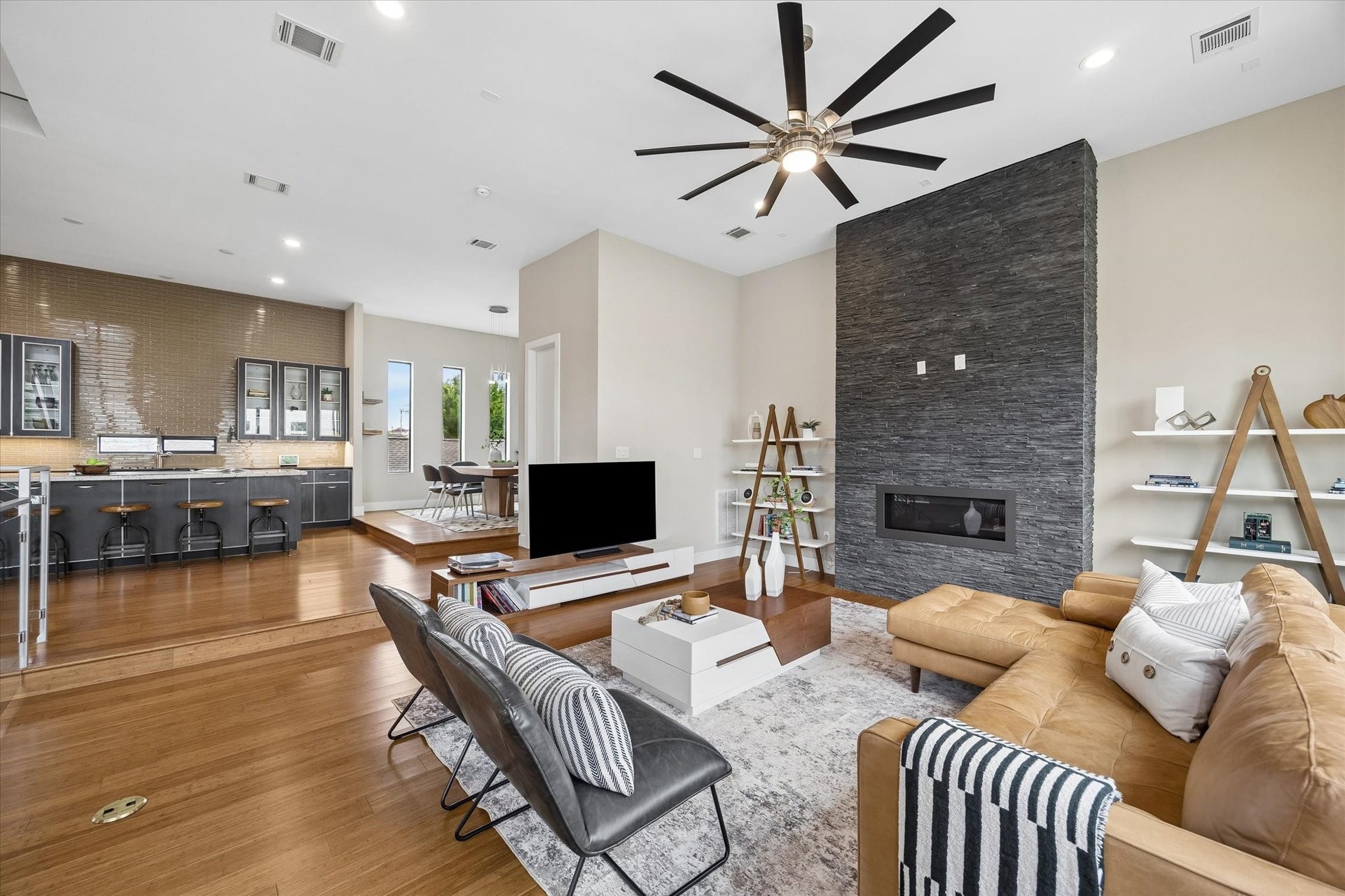 This second-floor living area brings everything together with an open layout that connects the living and dining areas, and the island kitchen with ease. Natural light, balcony access, and crisp contemporary finishes create a space that feels stylish, functional, and ready for everyday living or entertaining.