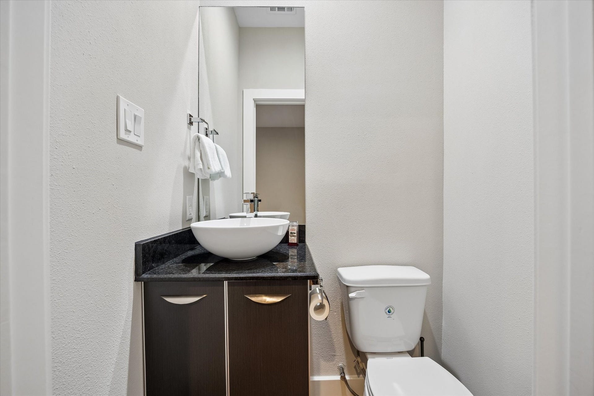 A rare and practical bonus, this second powder bath is conveniently located near the rooftop deck, making it convenient for guests during outdoor gatherings. The sleek vanity and vessel sink keep the look clean and modern while adding even more convenience to this well-designed layout.