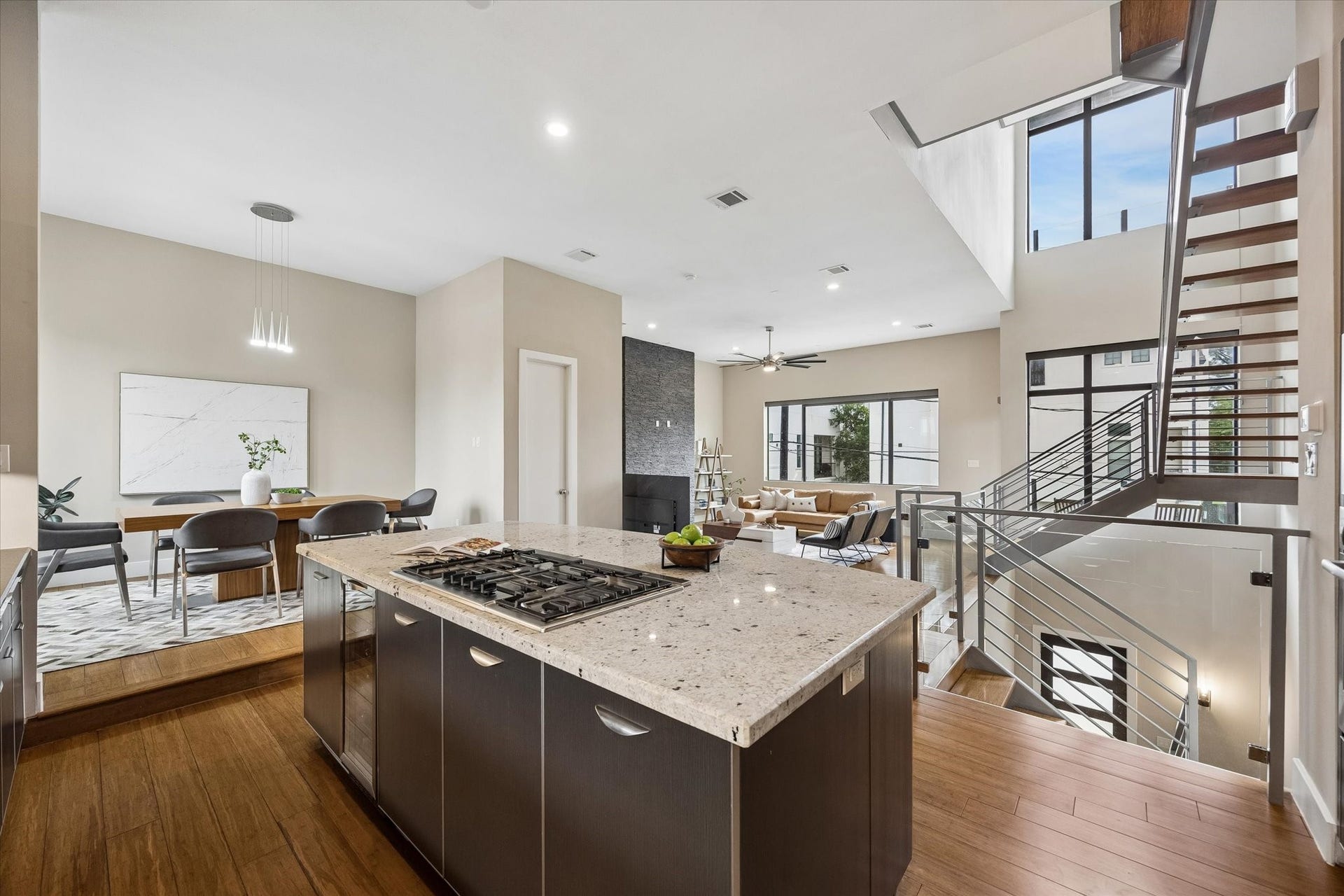 Open to the dining and living areas, the kitchen enjoys spectacular views across the main living level with picture windows, a see-through staircase, and natural light all around. It is a beautiful place to cook, gather, and stay connected while the homes bright modern design takes center stage.