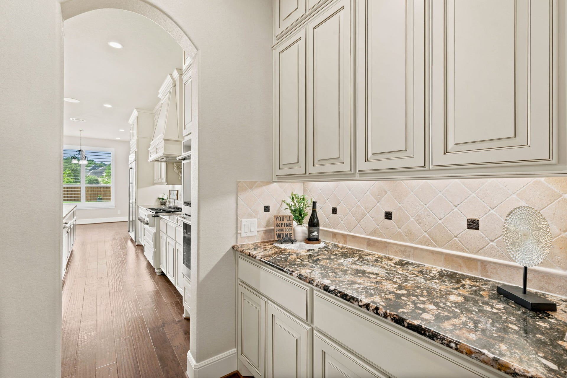 Butler's pantry with under cabinet lighting.