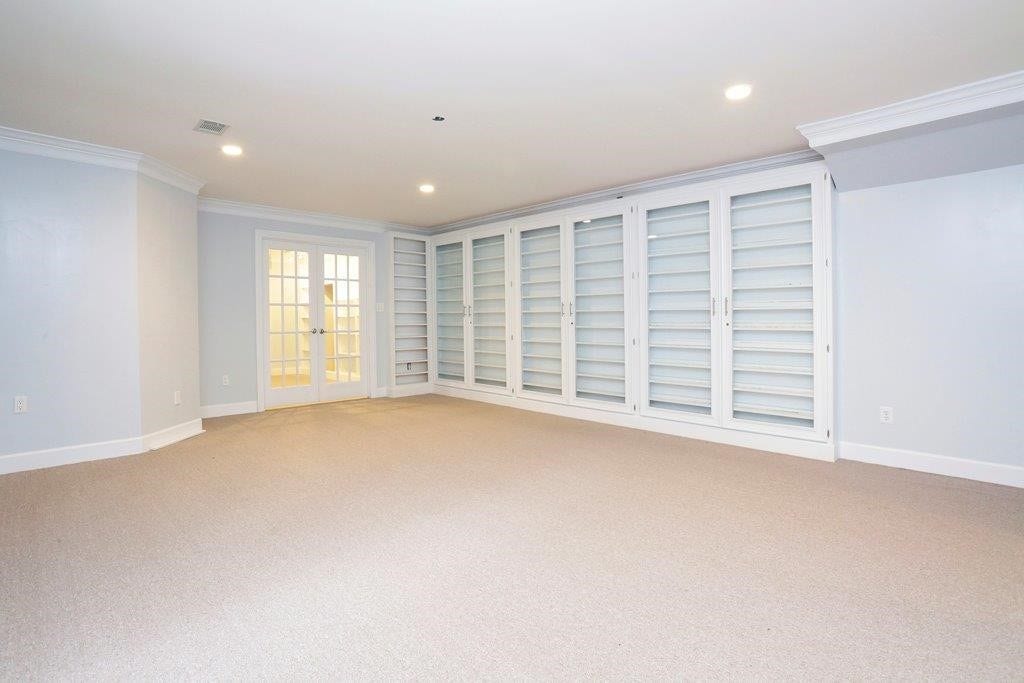 10210 Winding Wood Lane, Tomball, TX 77375 Game room with storage behind folding doors