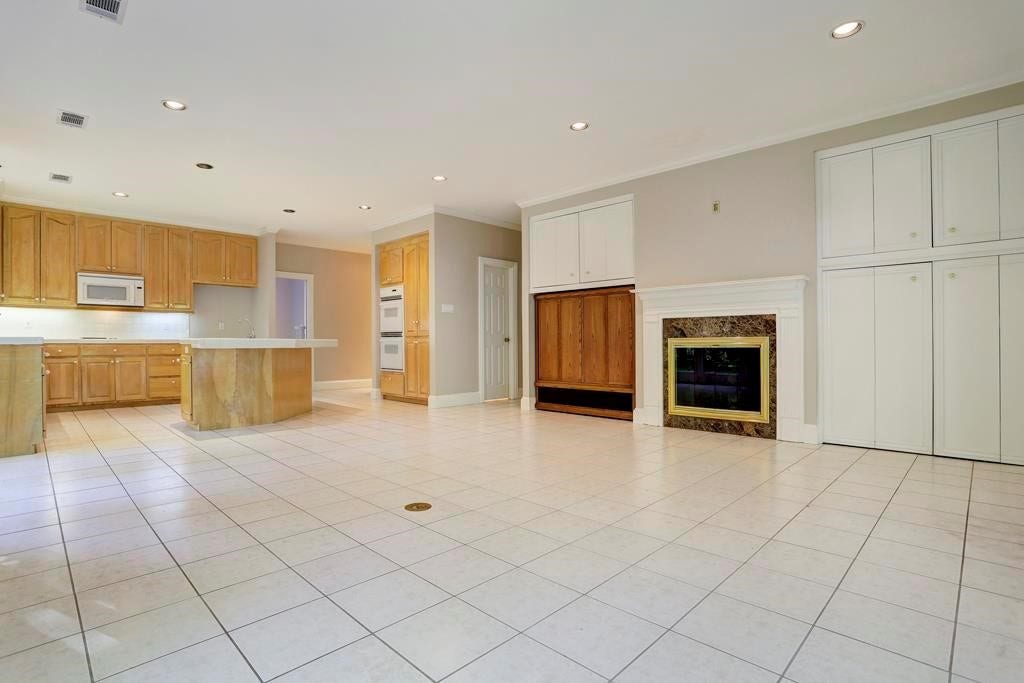 10210 Winding Wood Lane, Tomball, TX 77375 Family room with floor plug and fireplace