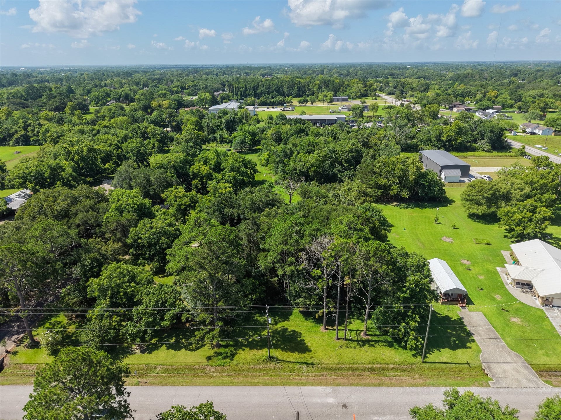 This aerial perspective highlights the property's direct access from 28th Street and its proximity to FM 646. The long rectangular configuration extends approximately 612' from front to rear, creating numerous possibilities for placing a residence, shop, outdoor living areas or other improvements. Electric, gas and cable are available at the street adding another important advantage when planning future development.