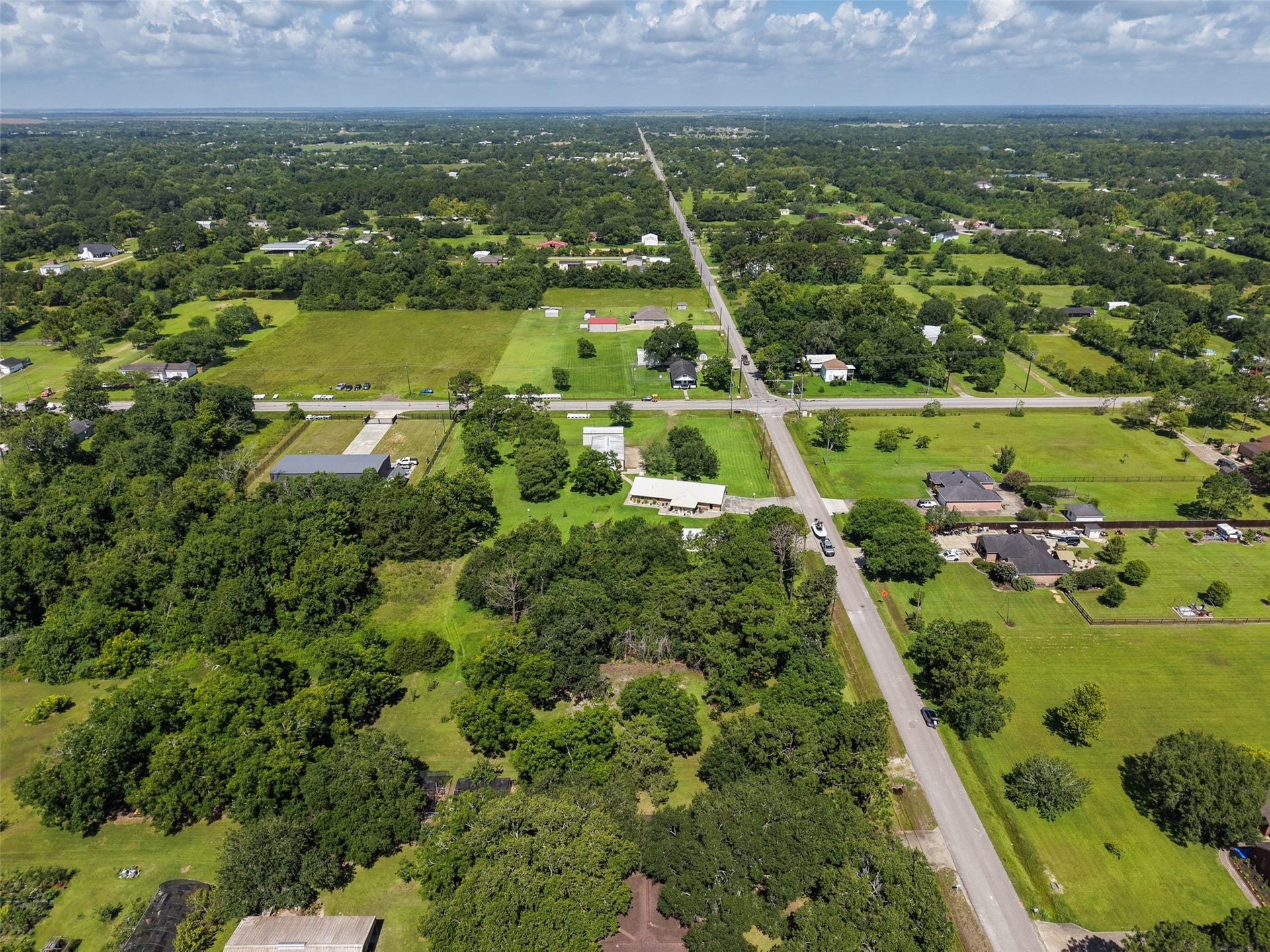 From higher elevation, the broader Santa Fe landscape comes into focus: large residential tracts, mature vegetation and open green space stretching toward the horizon. This is the setting buyers are seeking when they want more room than a traditional neighborhood can provide. The subject property delivers 1.56 acres while maintaining direct paved-road access and proximity to FM 646.