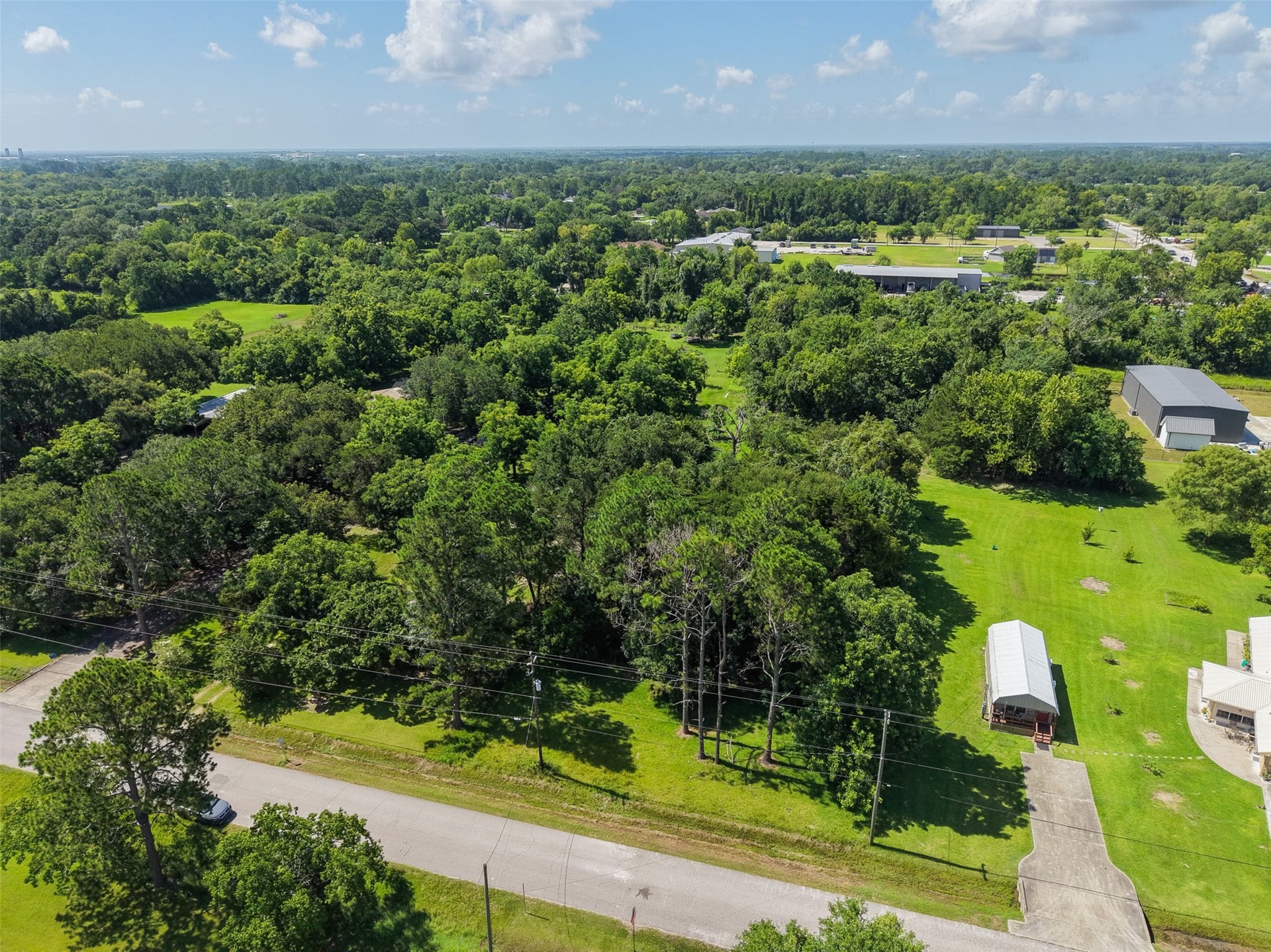 Enjoy the privacy and space associated with country living without giving up convenient access to everyday necessities. This aerial view shows the property's wooded surroundings and nearby residential acreage, while FM 646 and Highway 6 provide quick connections to local dining, shopping and services. Santa Fe H-E-B offers full-service grocery shopping right in Santa Fe.