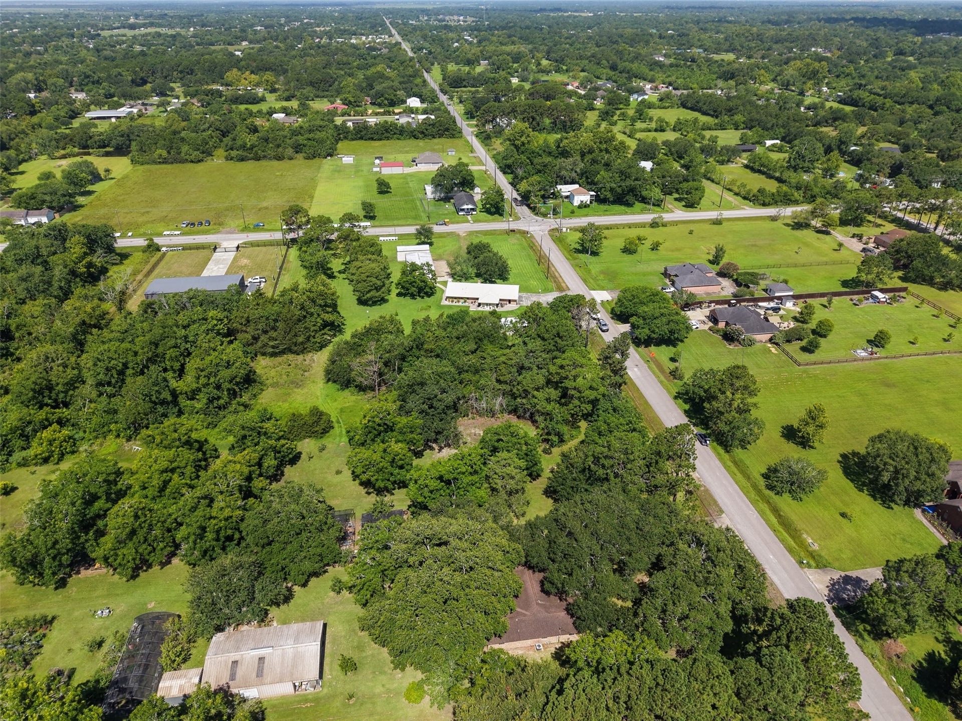 This aerial view highlights the visual depth created by alternating areas of open lawn and dense tree canopy throughout the surrounding landscape. The subject property offers the same appealing natural character, providing opportunities to preserve mature trees for shade and screening while creating open spaces around future improvements. It is an excellent foundation for a homesite designed around outdoor living and privacy.