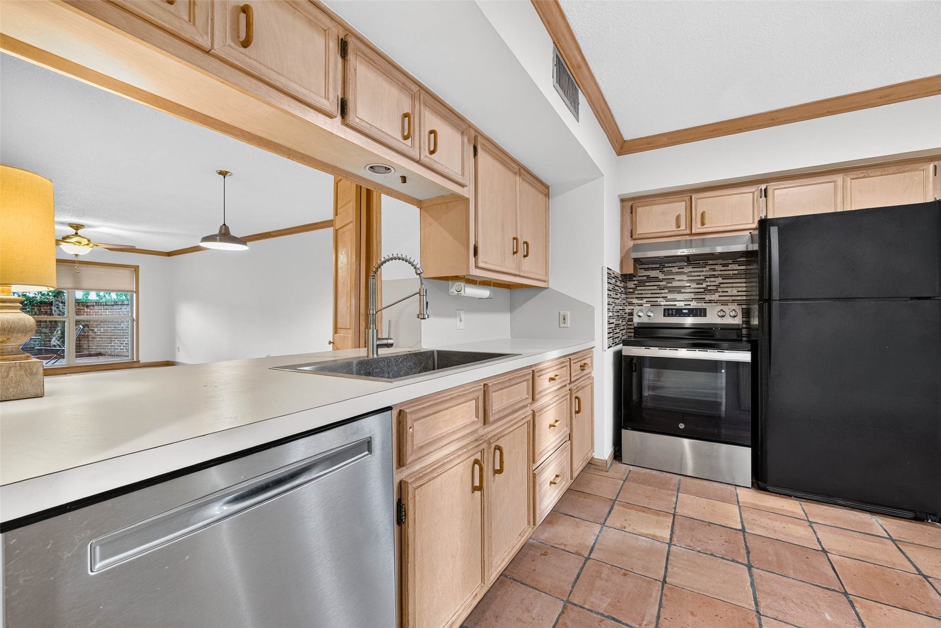 Charming kitchen seamlessly flowing into an inviting open-concept living area.