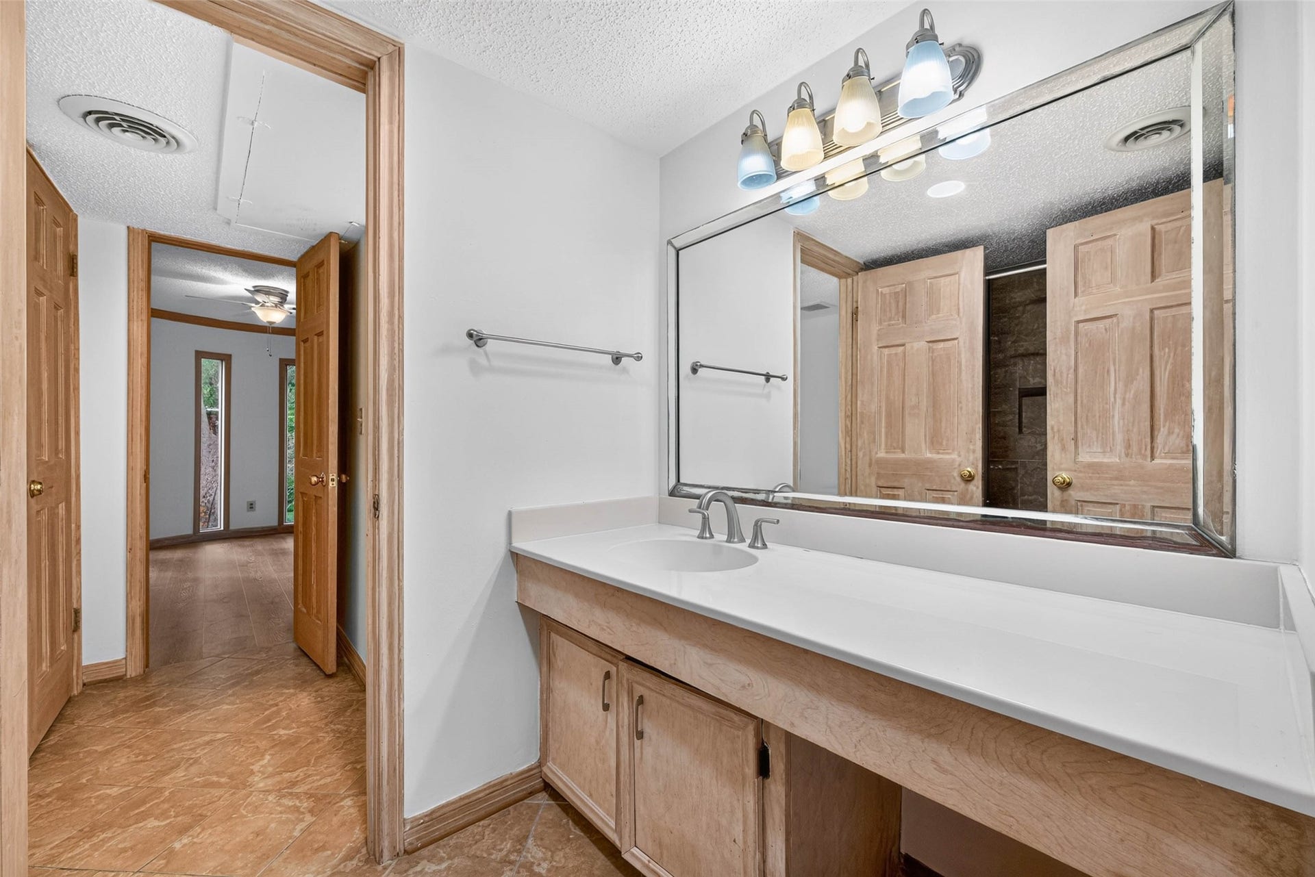 Spacious bathroom with a large vanity and mirror