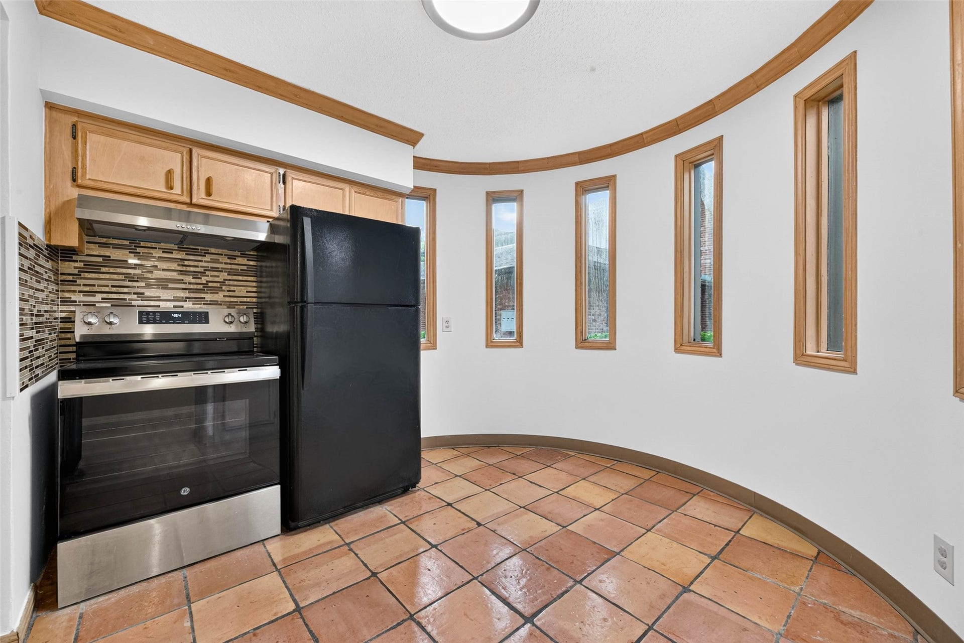 Charming kitchen nook featuring tall, narrow windows that fill the space with natural light.