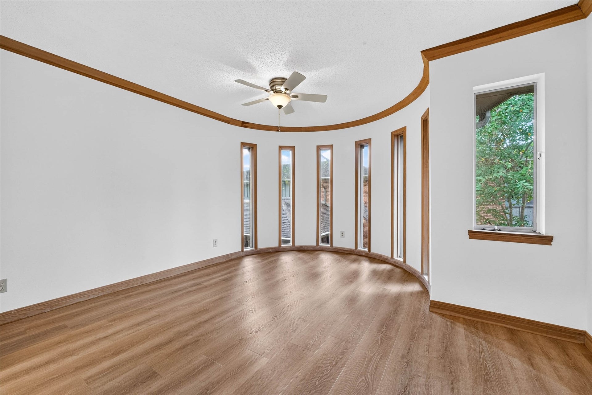 Bright, spacious room with elegant curved windows