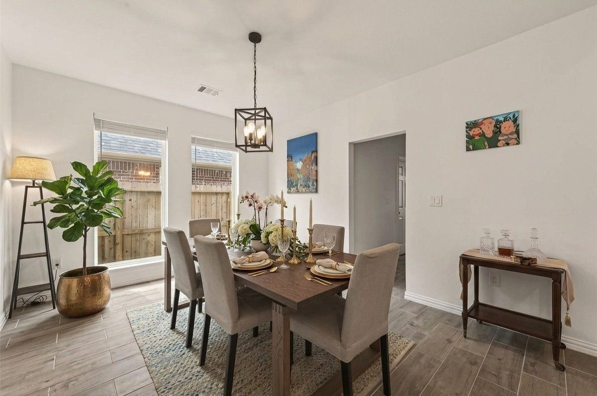 4423 Parkwater Cove Court SE, Sugar Land, TX 77479 This spacious dining room features a modern light fixture, has large windows for natural light, wood-look tile flooring, creating a warm and inviting space.