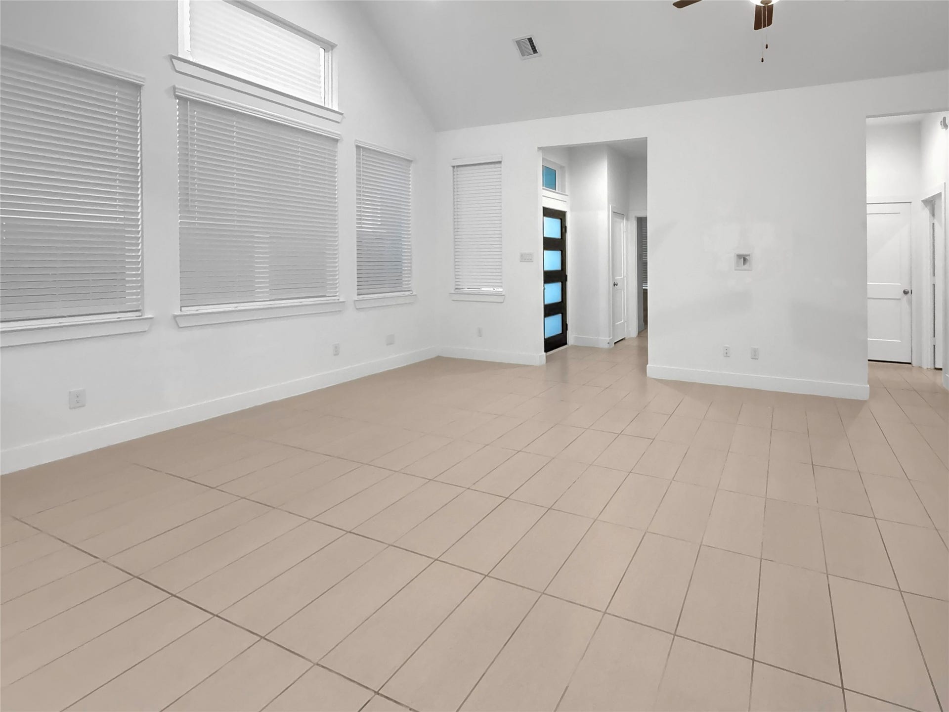 9407 Lantern Light Drive, Missouri City, TX 77459 Spacious living area featuring soaring ceilings, recessed lighting, and an open-concept layout.