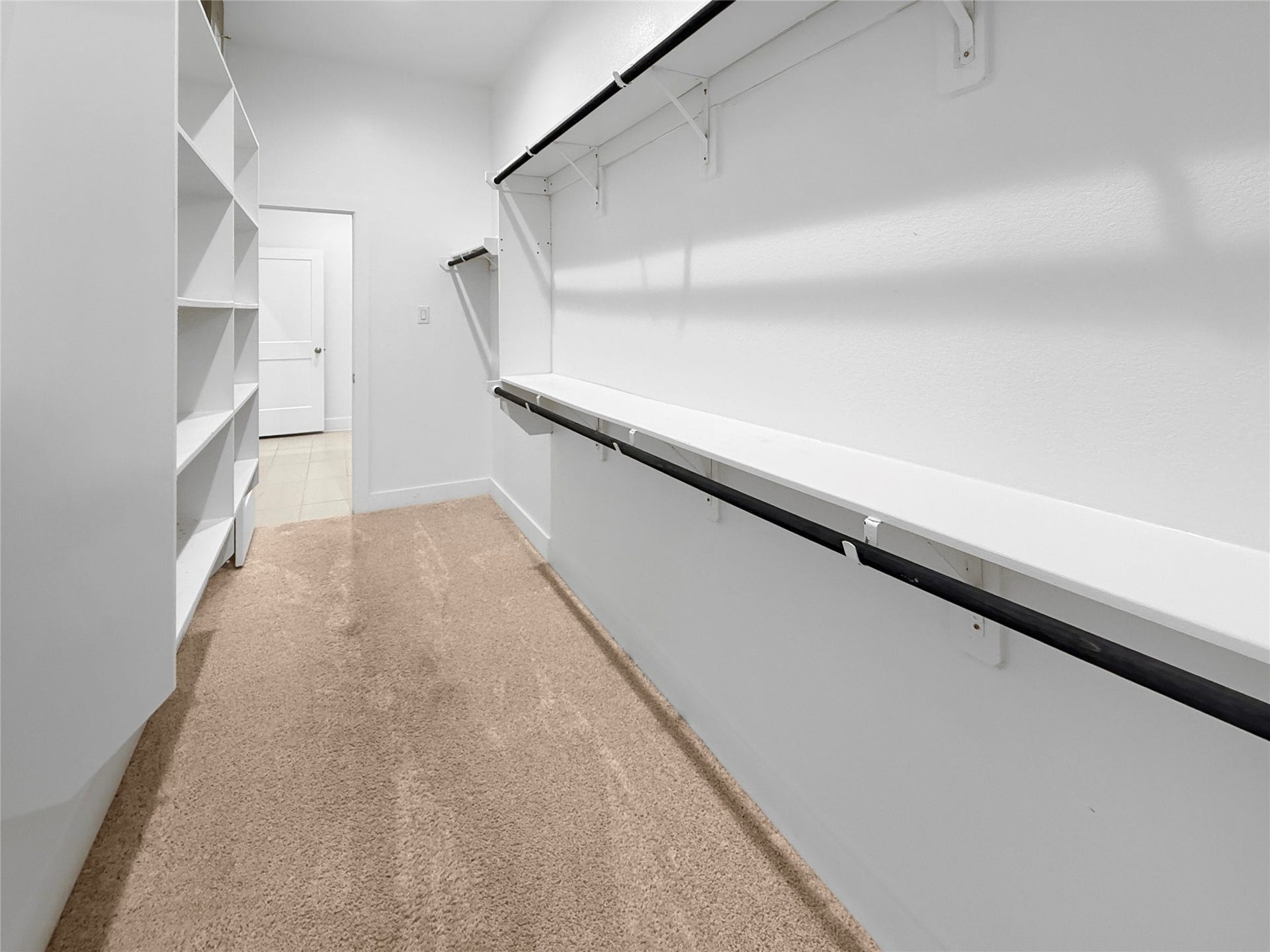 9407 Lantern Light Drive, Missouri City, TX 77459 Spacious primary walk-in closet featuring built-in shelving and ample storage space.