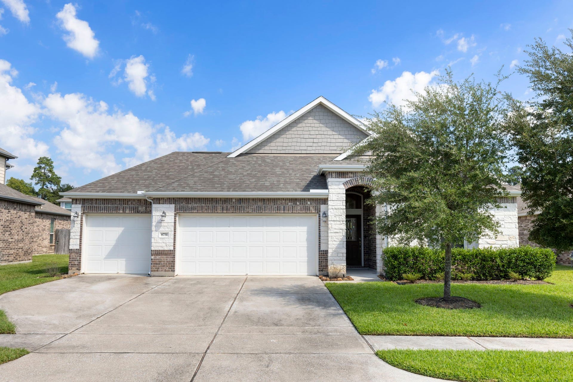 8731 Ute Creek Lane, Magnolia, TX 77354 Welcome home to 8731 Ute Creek Ln. Brick and stone exterior with a 3-car garage and wide driveway