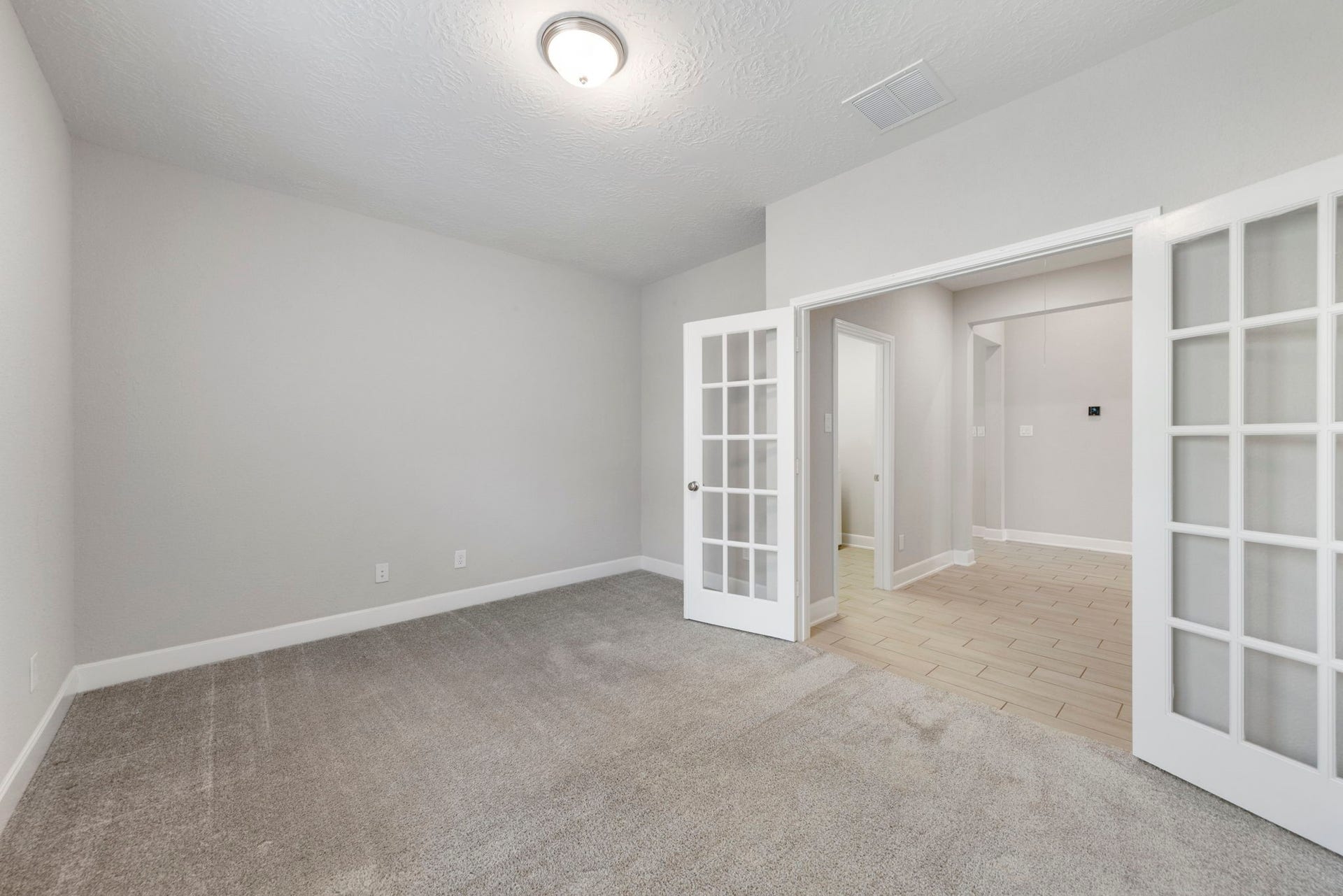 8731 Ute Creek Lane, Magnolia, TX 77354 Dedicated home office with French doors and natural light.