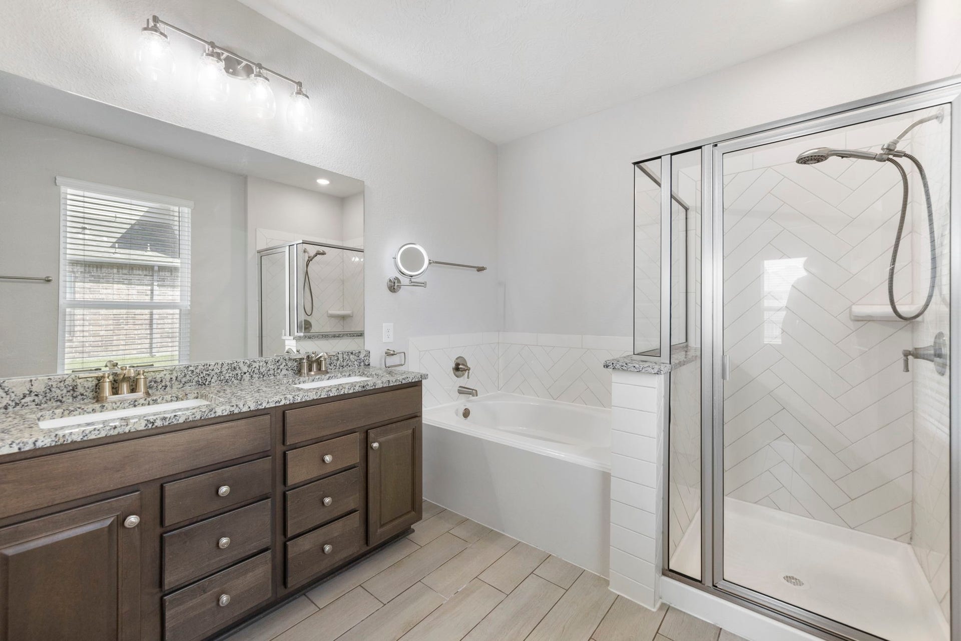 8731 Ute Creek Lane, Magnolia, TX 77354 Granite double vanity with rich wood cabinetry and plenty of drawer storage