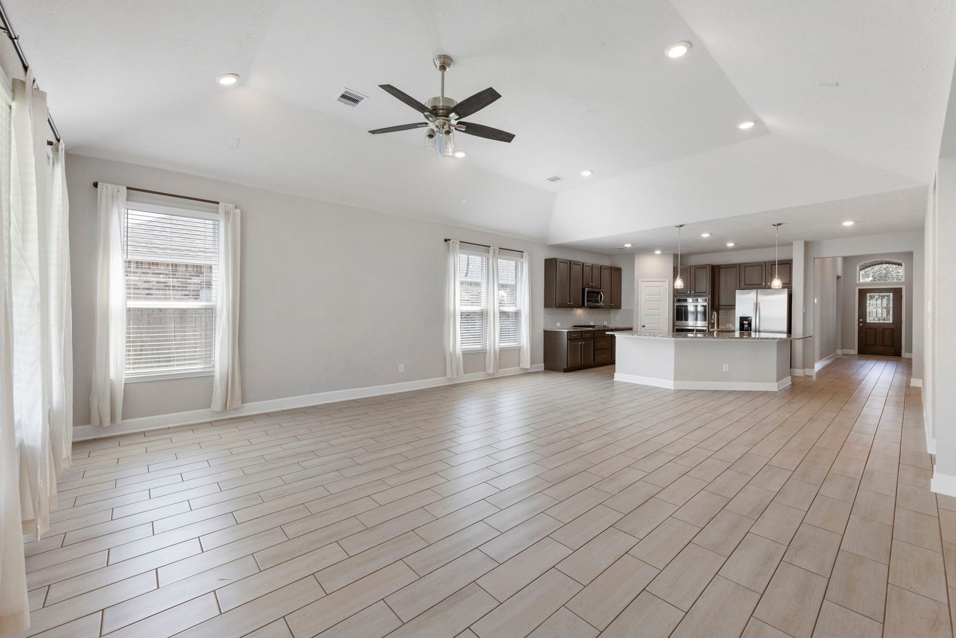 8731 Ute Creek Lane, Magnolia, TX 77354 Light-filled family room with a wall of windows and patio access