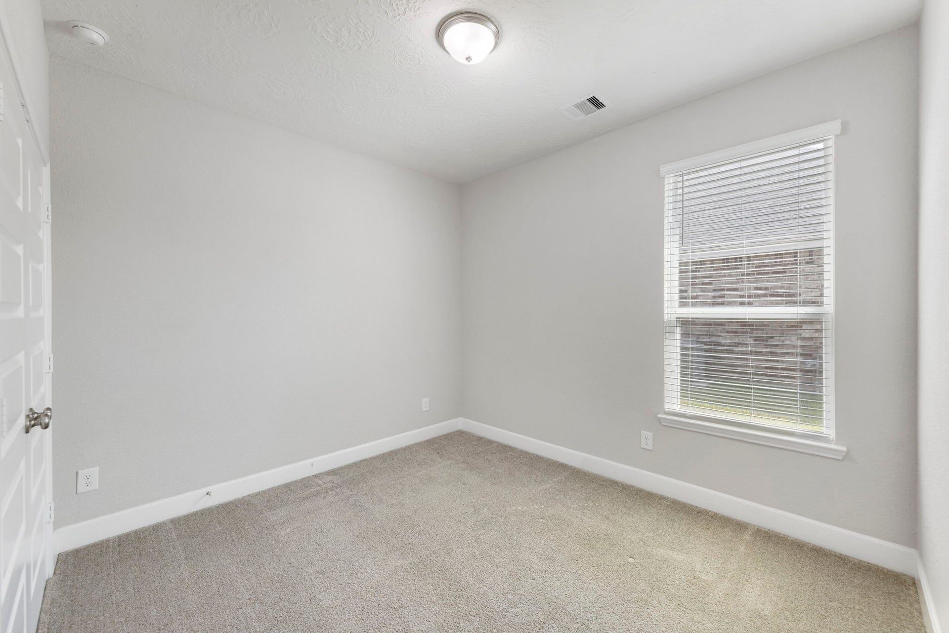 8731 Ute Creek Lane, Magnolia, TX 77354 Comfortable secondary bedroom with neutral paint, ready for your personal touch.