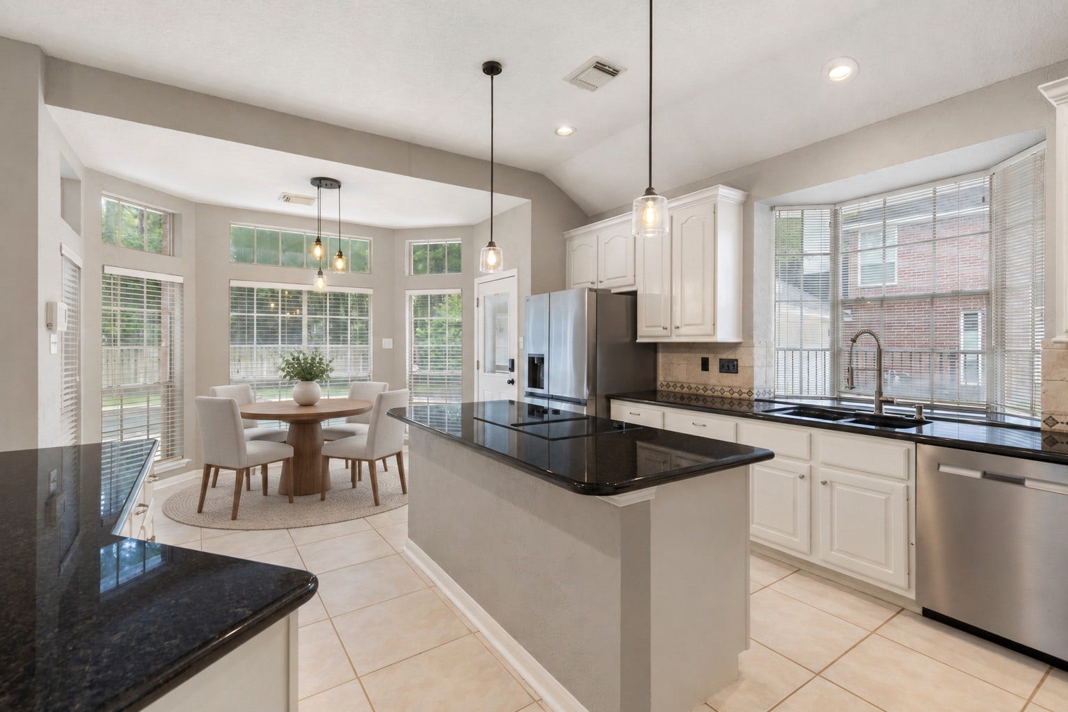27 Stargazer Place, The Woodlands, TX 77381 VIRTUALLY STAGED - There is one island which contains the Electric Cooktop and storage, but there is a GAS Connection Below the island.