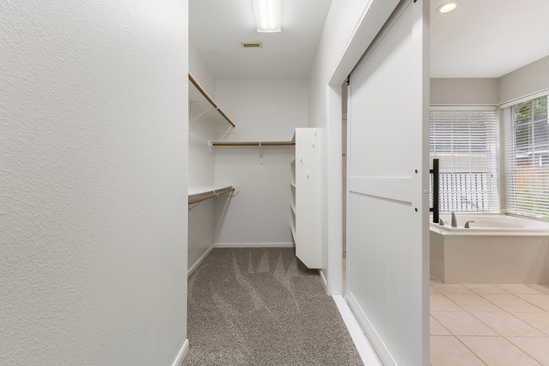27 Stargazer Place, The Woodlands, TX 77381 A lovely barn door allows for easy access to the walk-in closet.