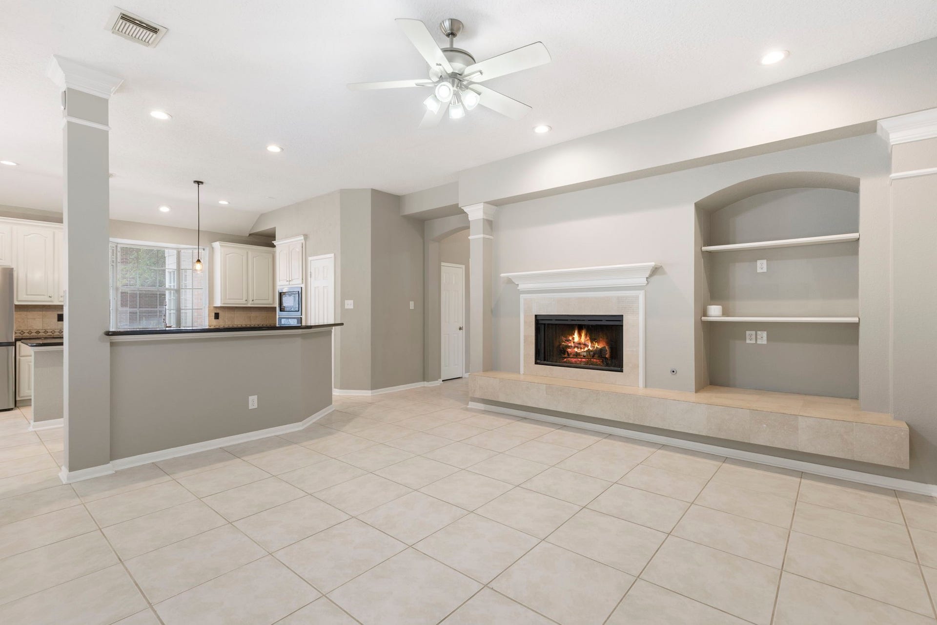 27 Stargazer Place, The Woodlands, TX 77381 There is a cozy fireplace with opportunity to place the TV over the mantle or along the wall for viewing from the Kitchen.