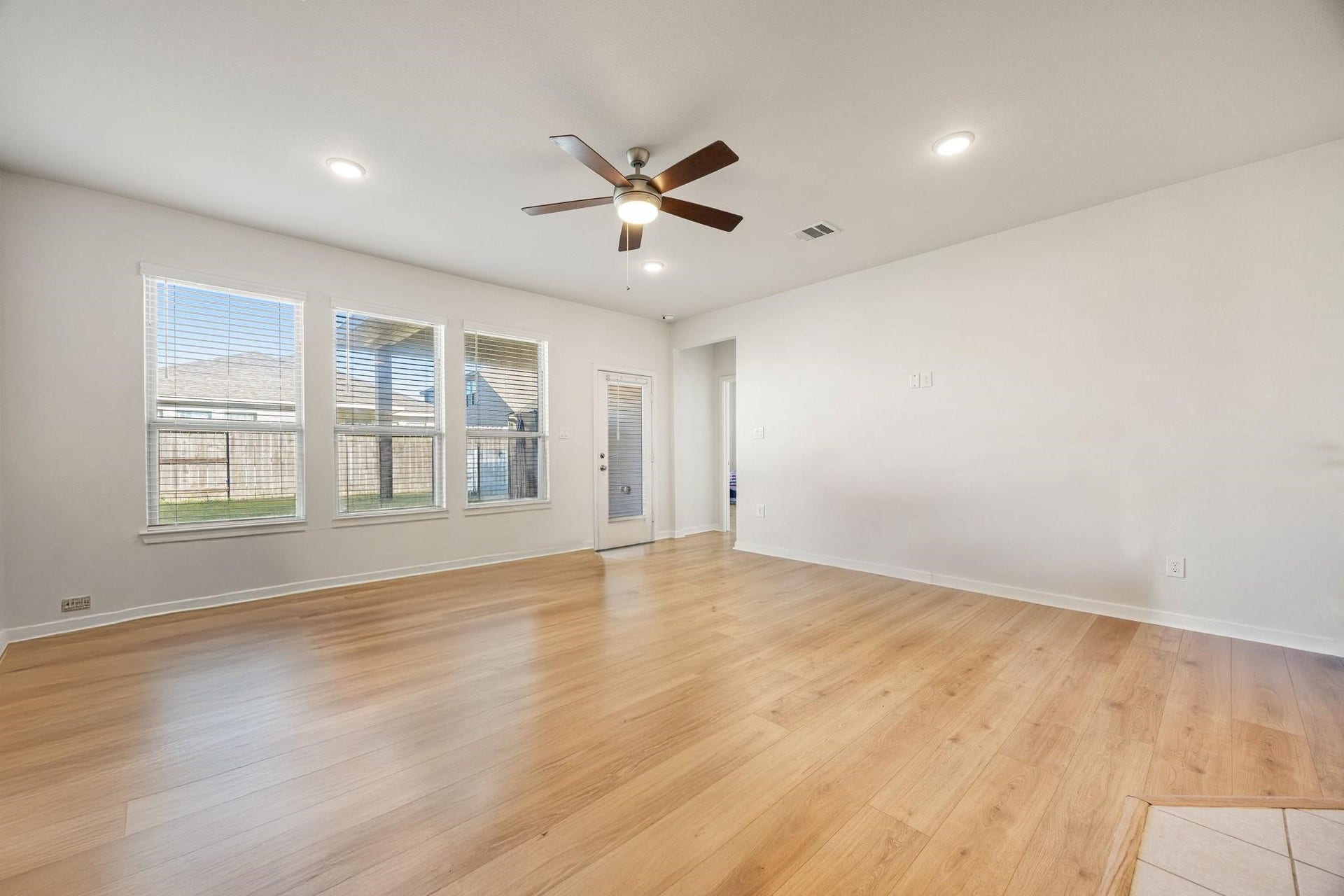 8106 Colony Chase Court, Richmond, TX 77407 Open living area featuring wood-look flooring and a ceiling fan.