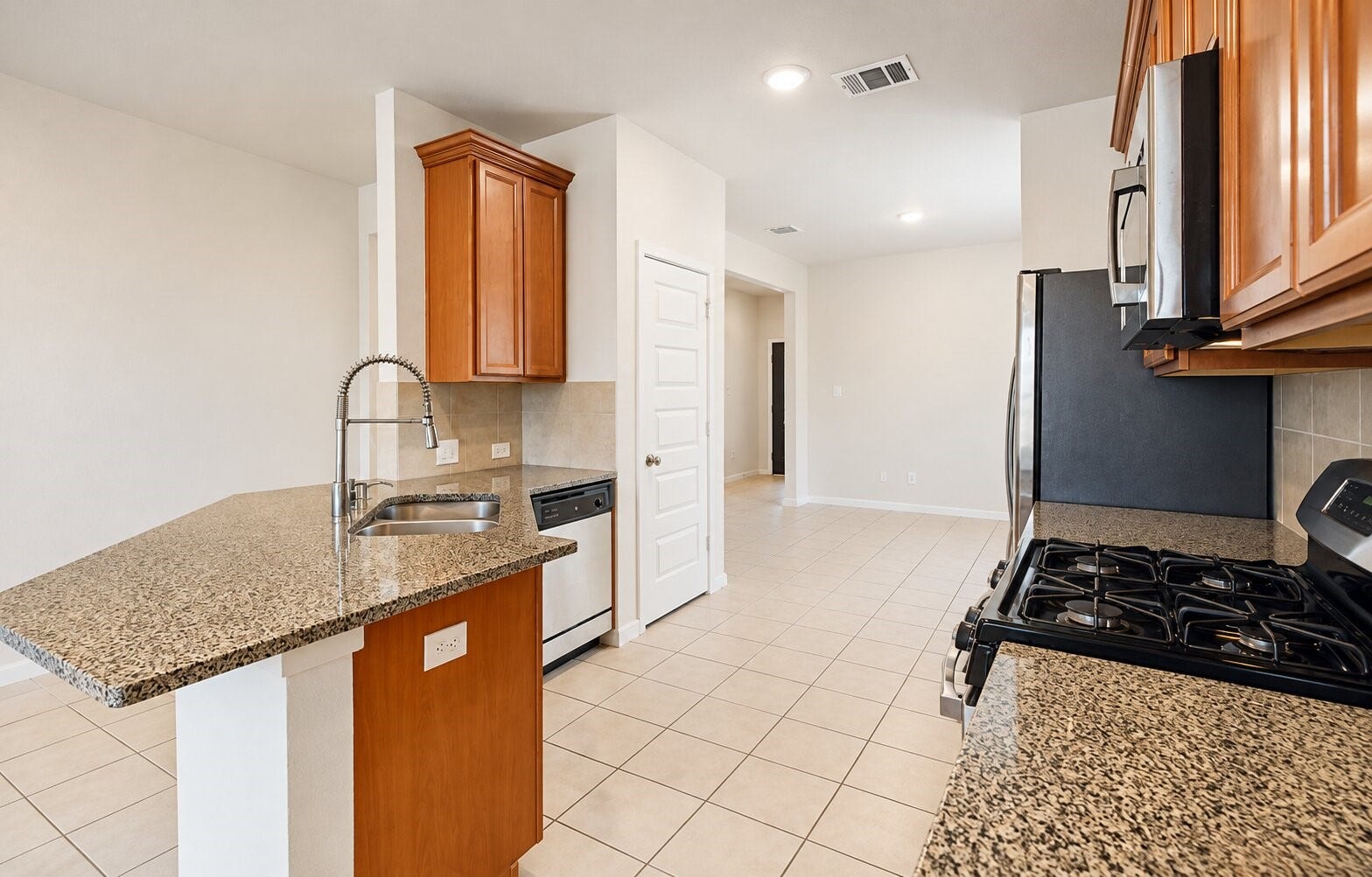 8106 Colony Chase Court, Richmond, TX 77407 Additional kitchen view highlighting the breakfast bar and cabinetry.