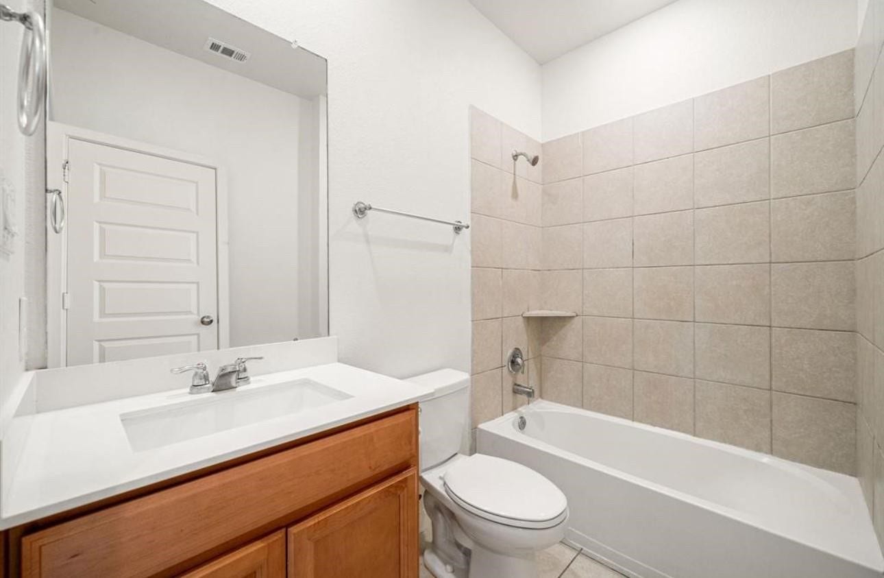 8106 Colony Chase Court, Richmond, TX 77407 Bathroom with a bathtub and tiled shower surround.