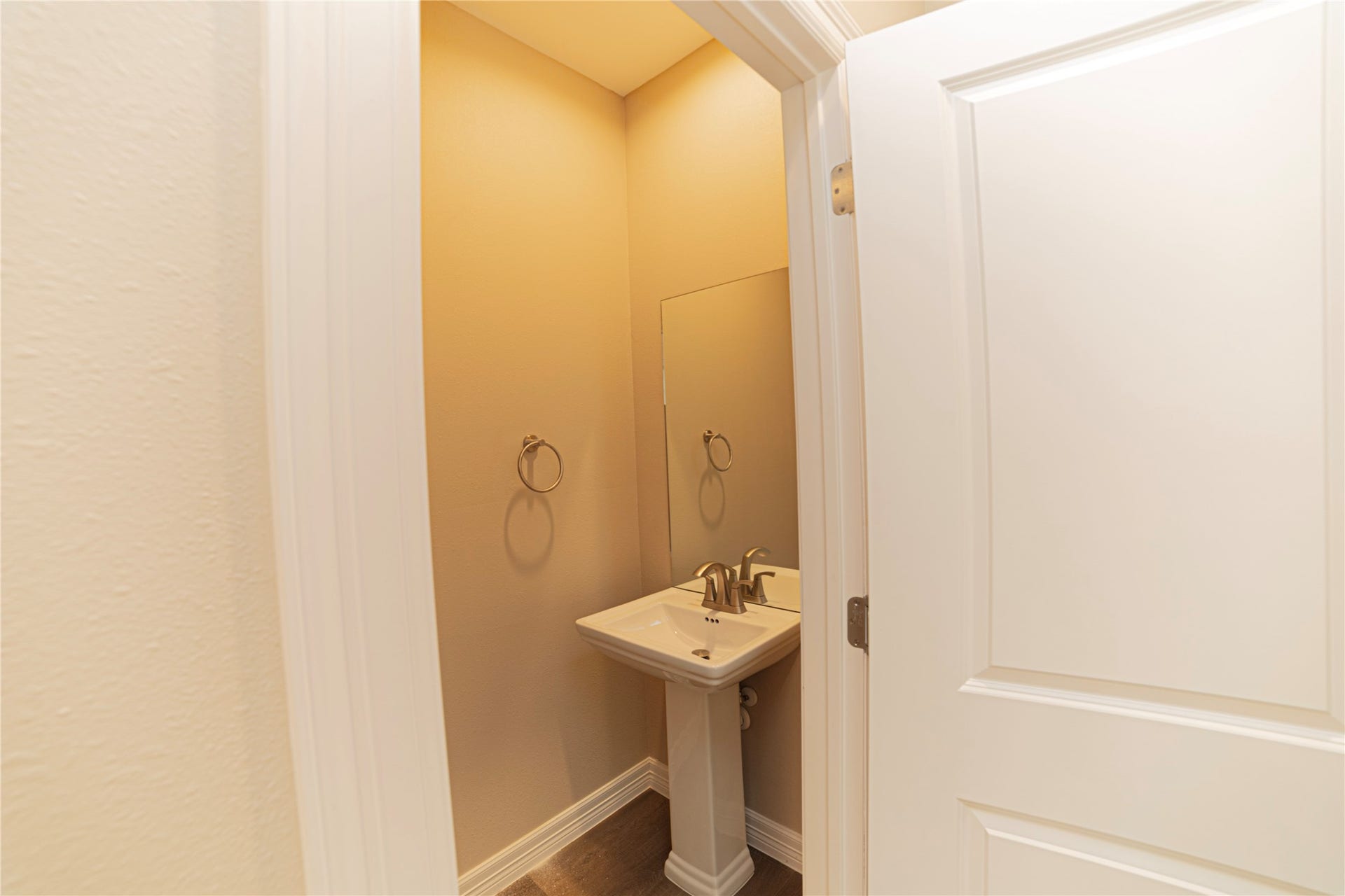 3252 Creekmont Drive, Houston, TX 77091 Cozy half-bath featuring a sleek pedestal sink, elegant fixtures, and warm lighting for a welcoming touch.