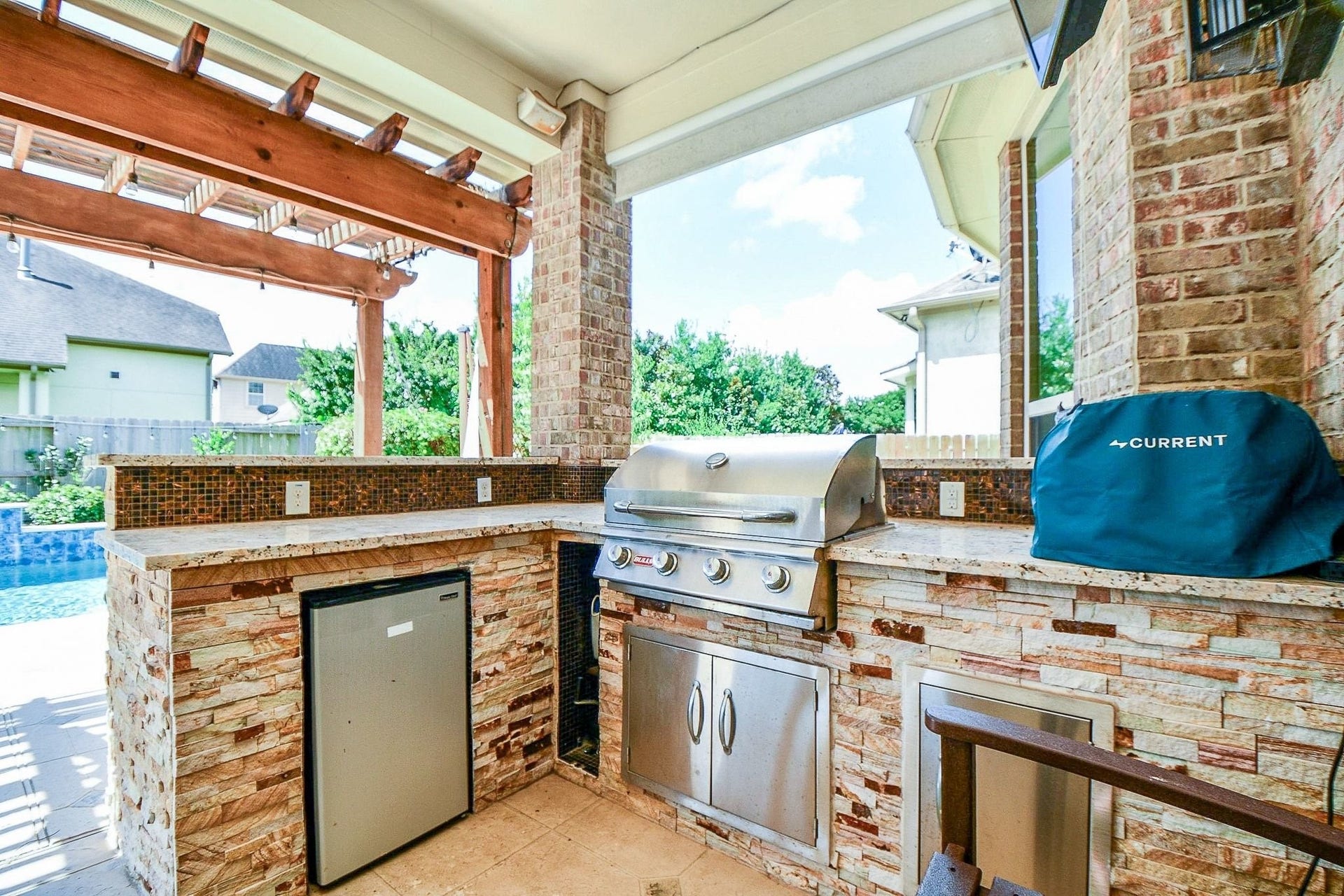 11410 Sardinia Drive, Richmond, TX 77406 Enjoy afternoons grilling and entertaining in this beautifully designed outdoor kitchen, featuring luxurious stacked stone, granite countertops, and a decorative tile backsplash that adds the perfect blend of color and character.