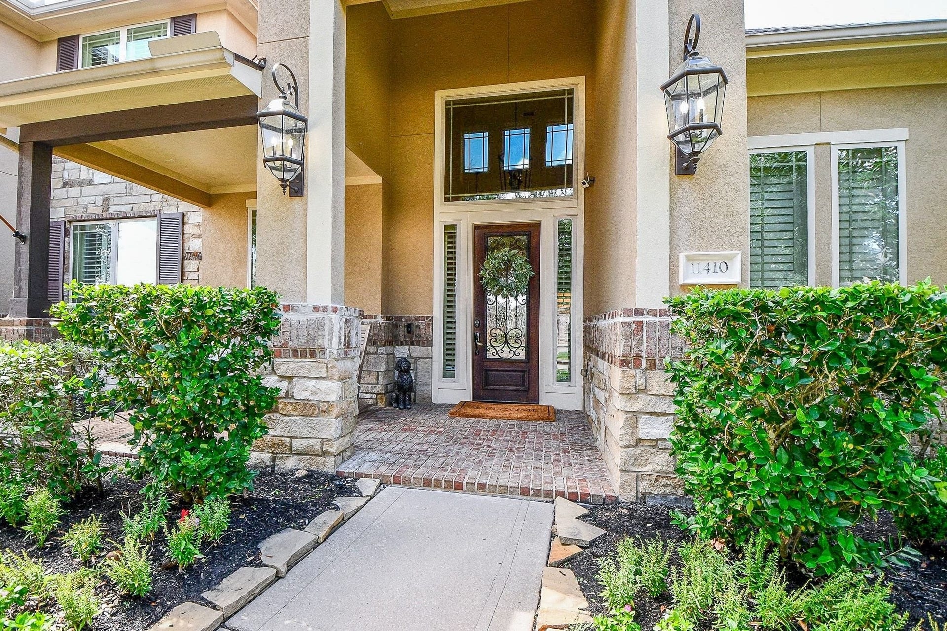 11410 Sardinia Drive, Richmond, TX 77406 The grand entry makes a beautiful first impression, with elegant glass and iron detailing on the front door, complemented by coordinating sidelights and a large transom window above.