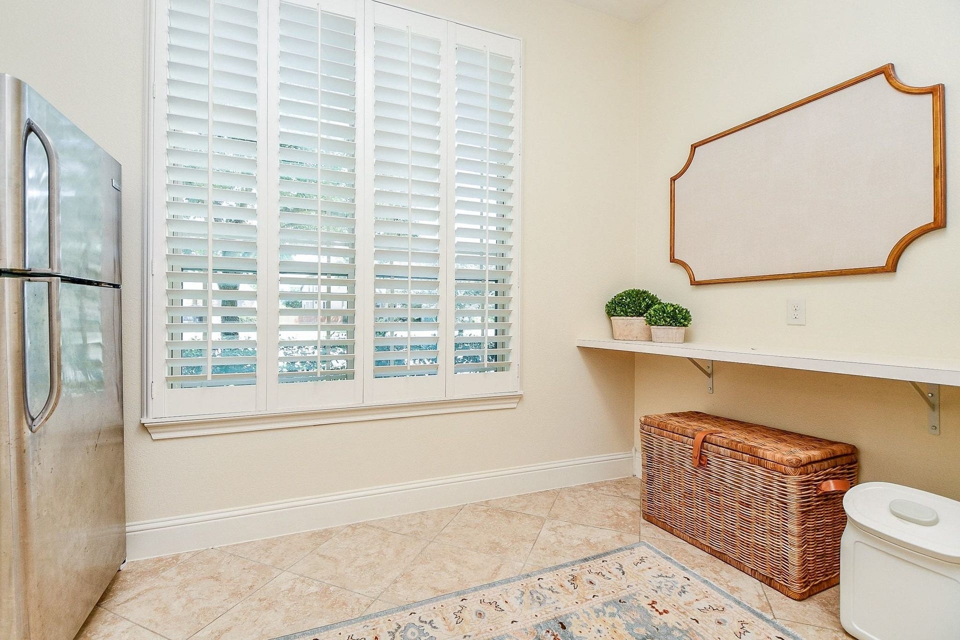 11410 Sardinia Drive, Richmond, TX 77406 Another view of the expansive utility room, featuring a large window with plantation shutters that fills the space with natural light and creates a bright, welcoming atmosphere for tackling laundry day.