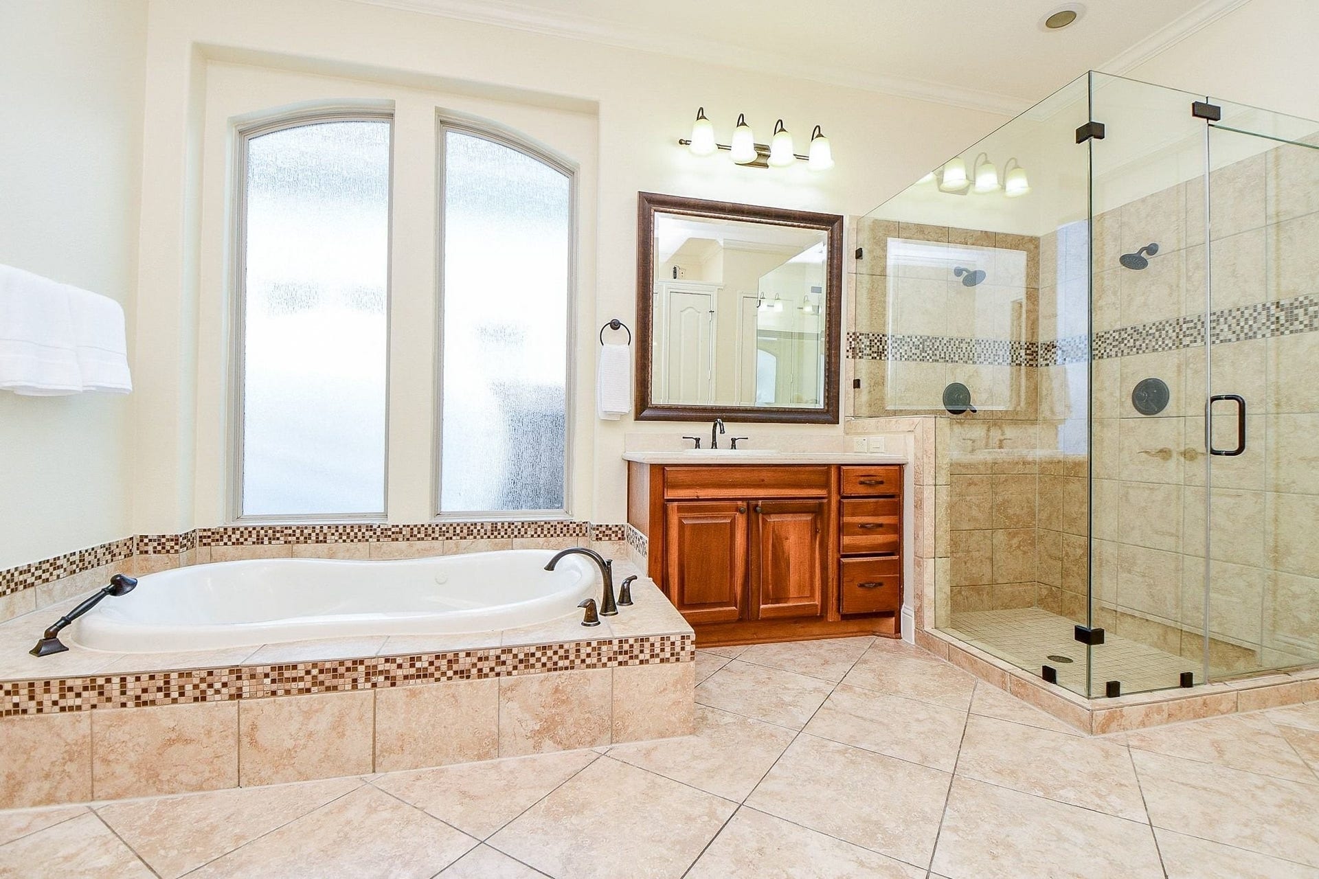 11410 Sardinia Drive, Richmond, TX 77406 This primary bathroom offers an oversized walk in shower with dual showerheads, sunken jetted tub, his and hers sinks with a vanity area and a huge walk in closet.