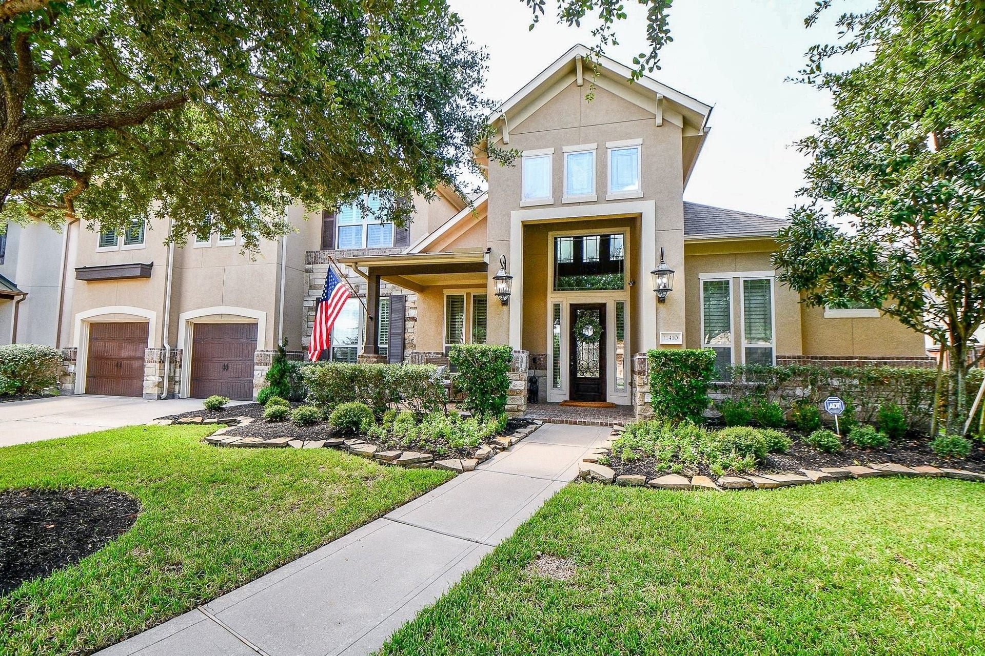 11410 Sardinia Drive, Richmond, TX 77406 This home makes a stunning first impression with its elegant stucco exterior, beautifully complemented by stone accents, low-maintenance landscaping, and charming lanterns.