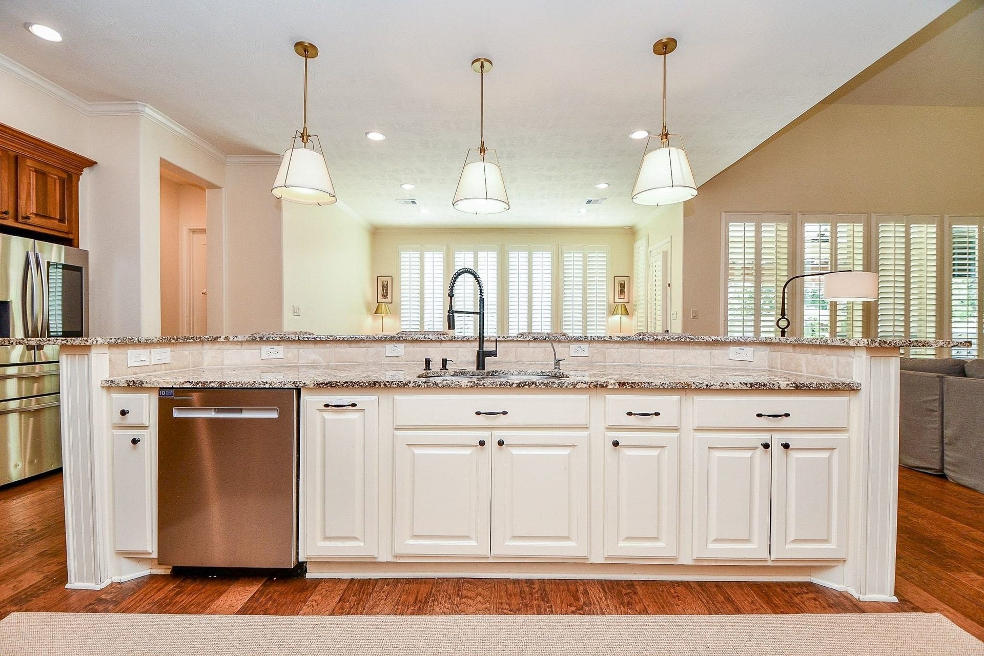 11410 Sardinia Drive, Richmond, TX 77406 Another view of the oversized island showcases just how much generous counter space it provides. Unique pendant lighting paired with abundant recessed lighting keeps the kitchen bright, inviting, and perfectly suited for gathering, cooking, and everyday living.