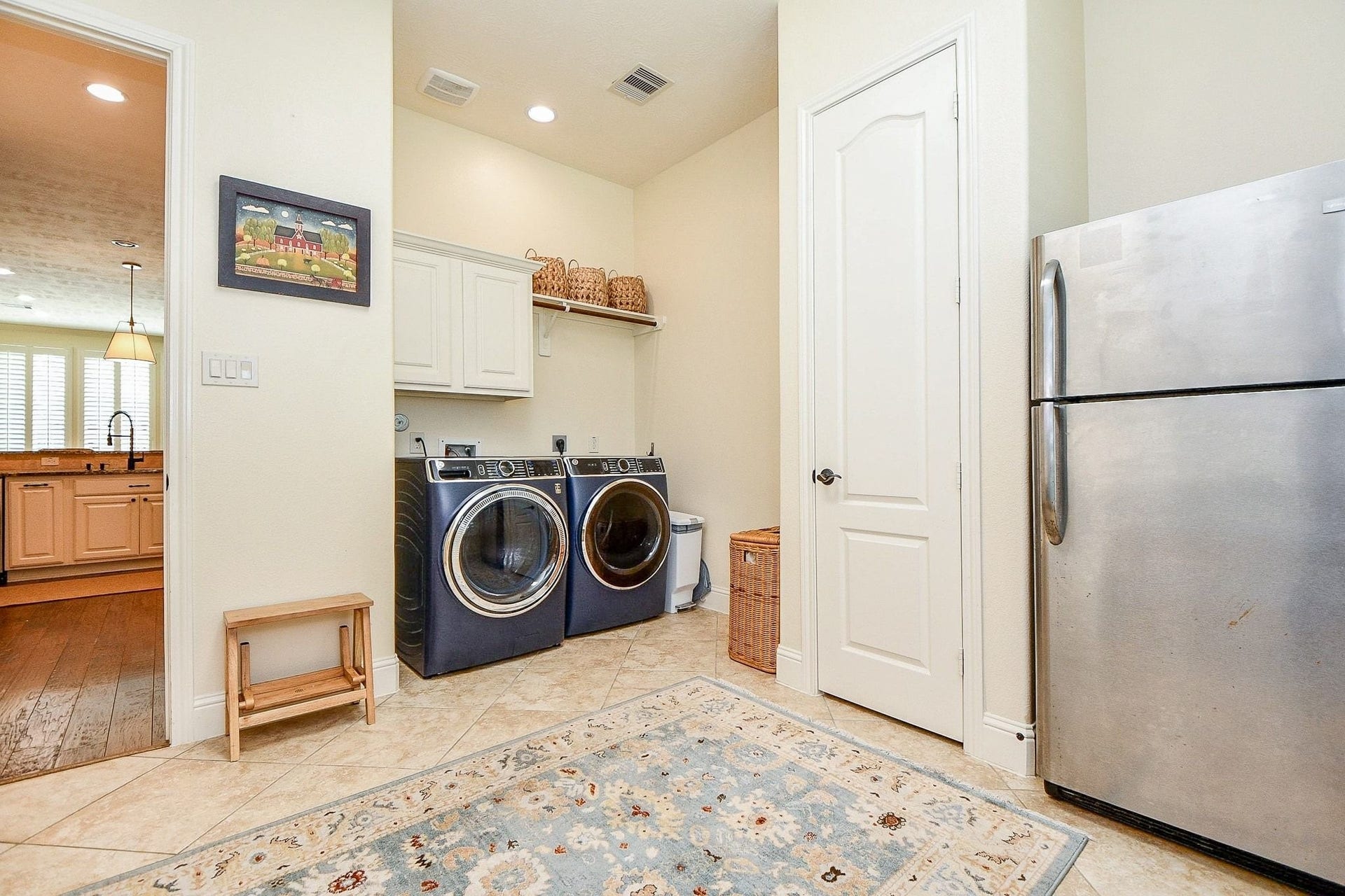 11410 Sardinia Drive, Richmond, TX 77406 This home features a spacious utility room with a convenient broom closet, dedicated space for a second refrigerator or freezer, and a designated area for folding laundry.